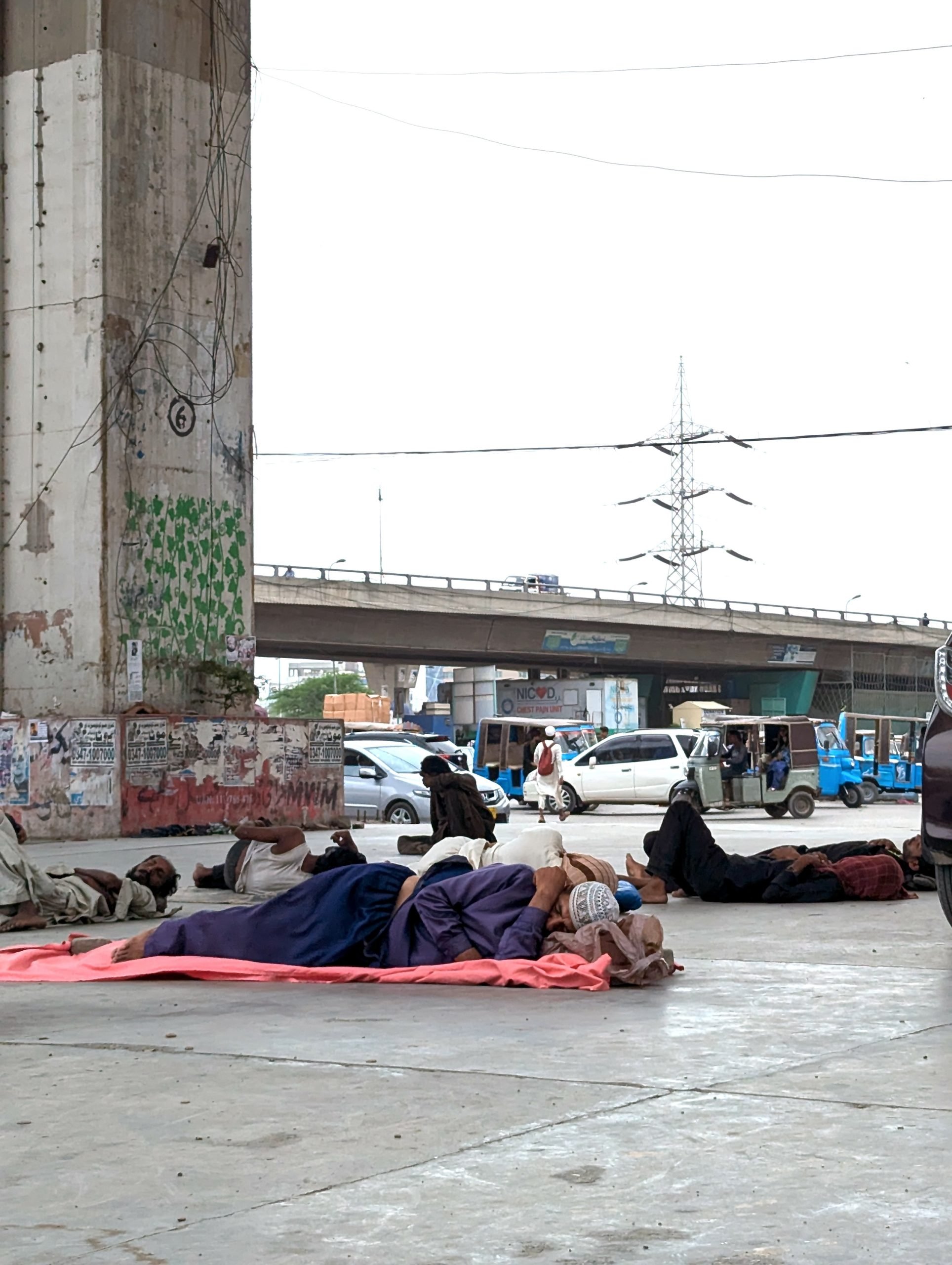 people taking shade and rest under a flyover