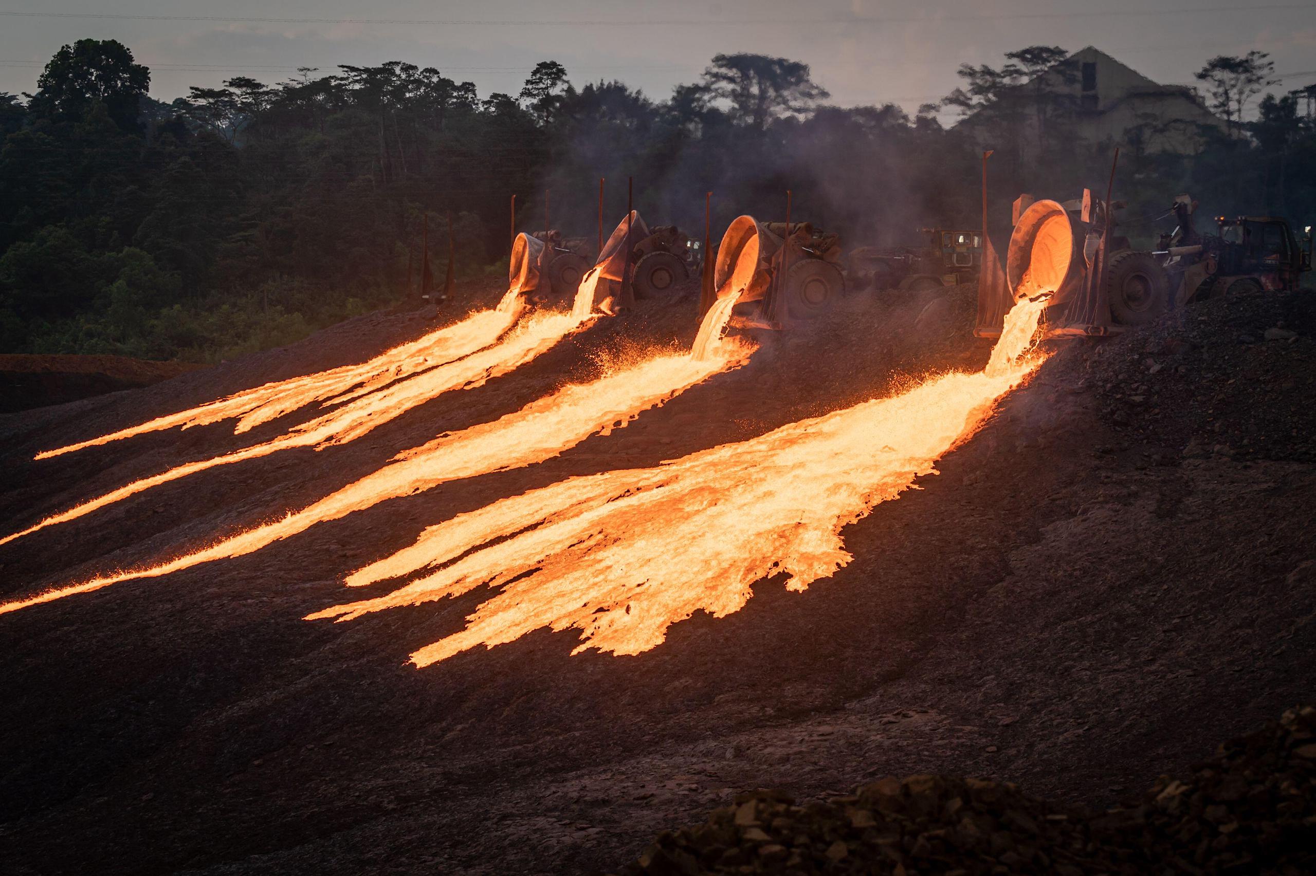 <p>Four trucks dump slag at a nickel-processing plant in Sorowako, South Sulawesi (Image: SOPA Images / Alamy)</p>