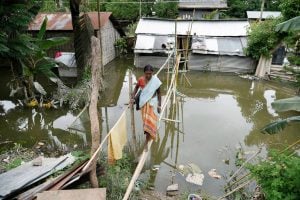 woman walking on bamboo bridge over water