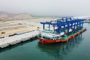 A large ship floats at a port