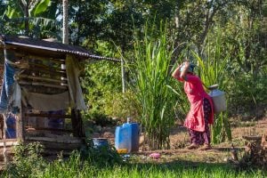 a woman carrying a water tank