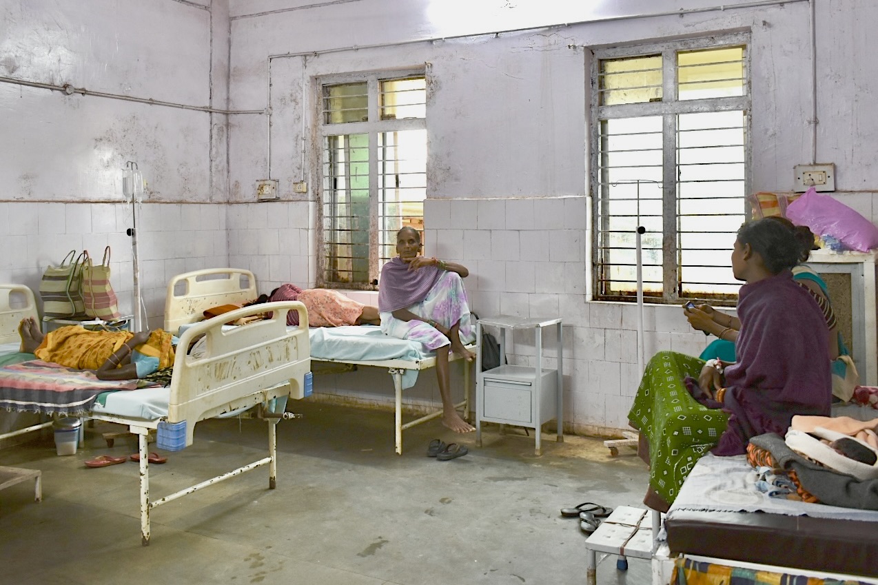 women sitting and laying on hospital beds