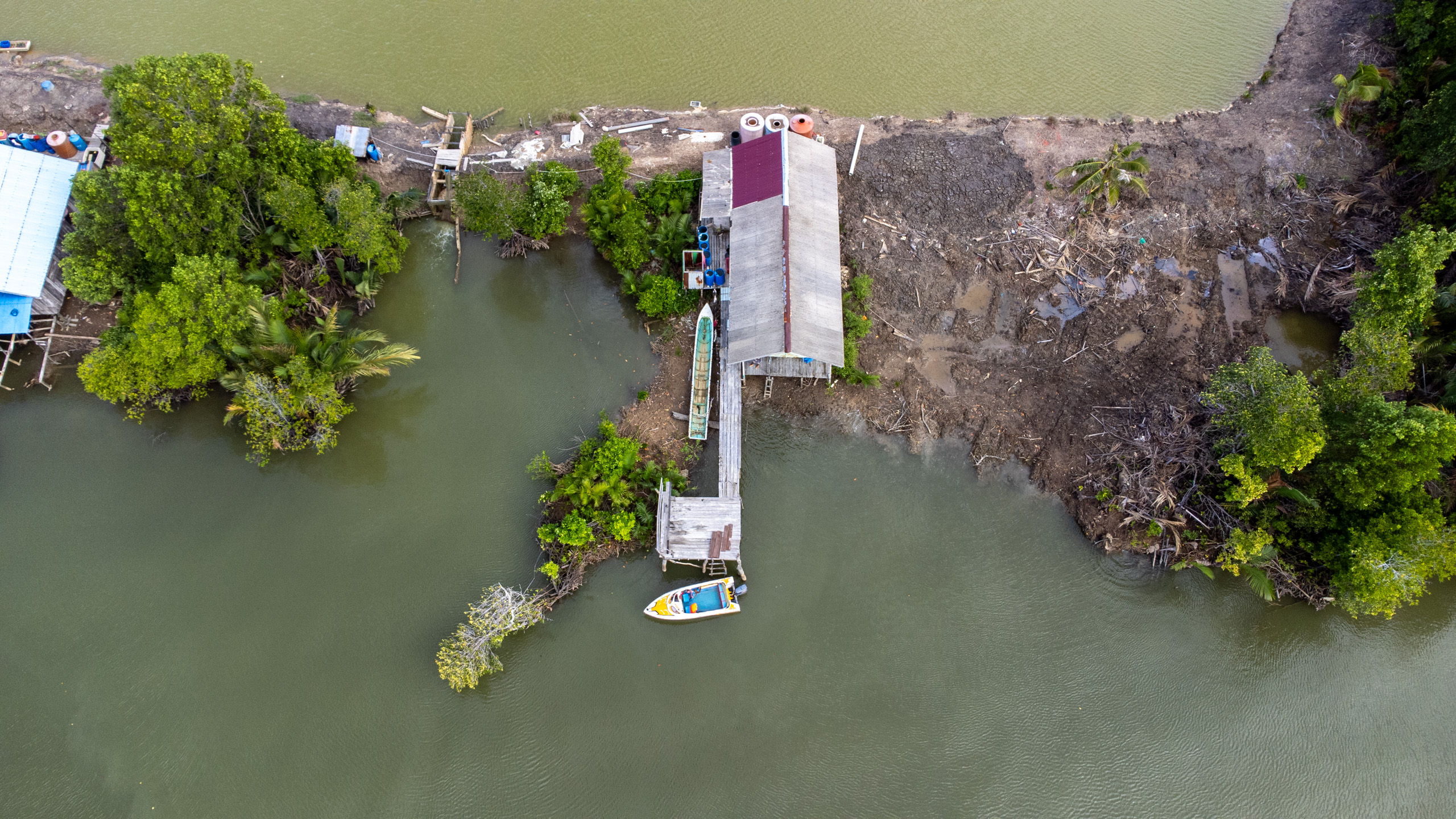 a house stands at the river banks