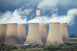 Multiple cooling towers releasing smoke