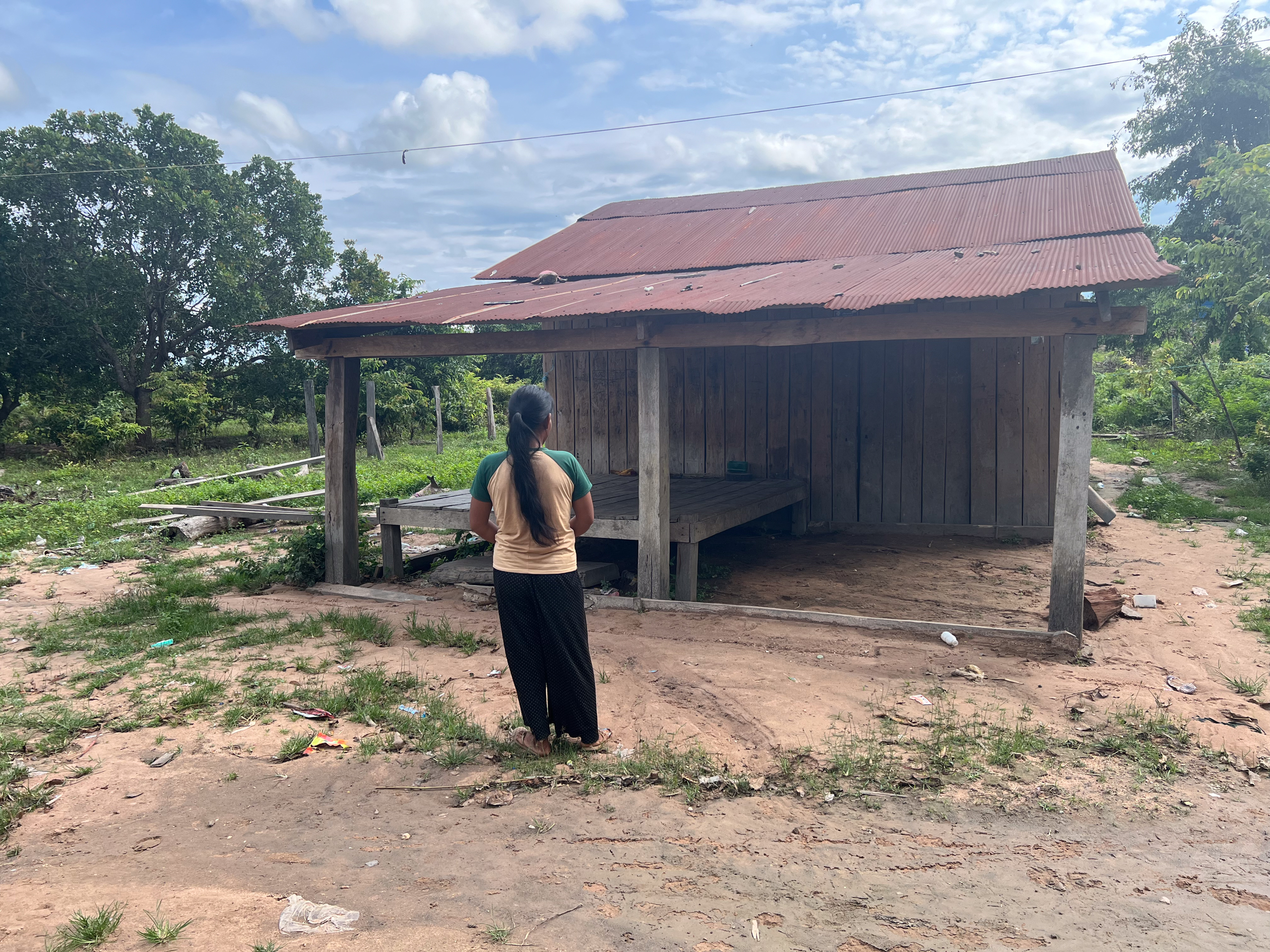 woman standing in front of wooden building