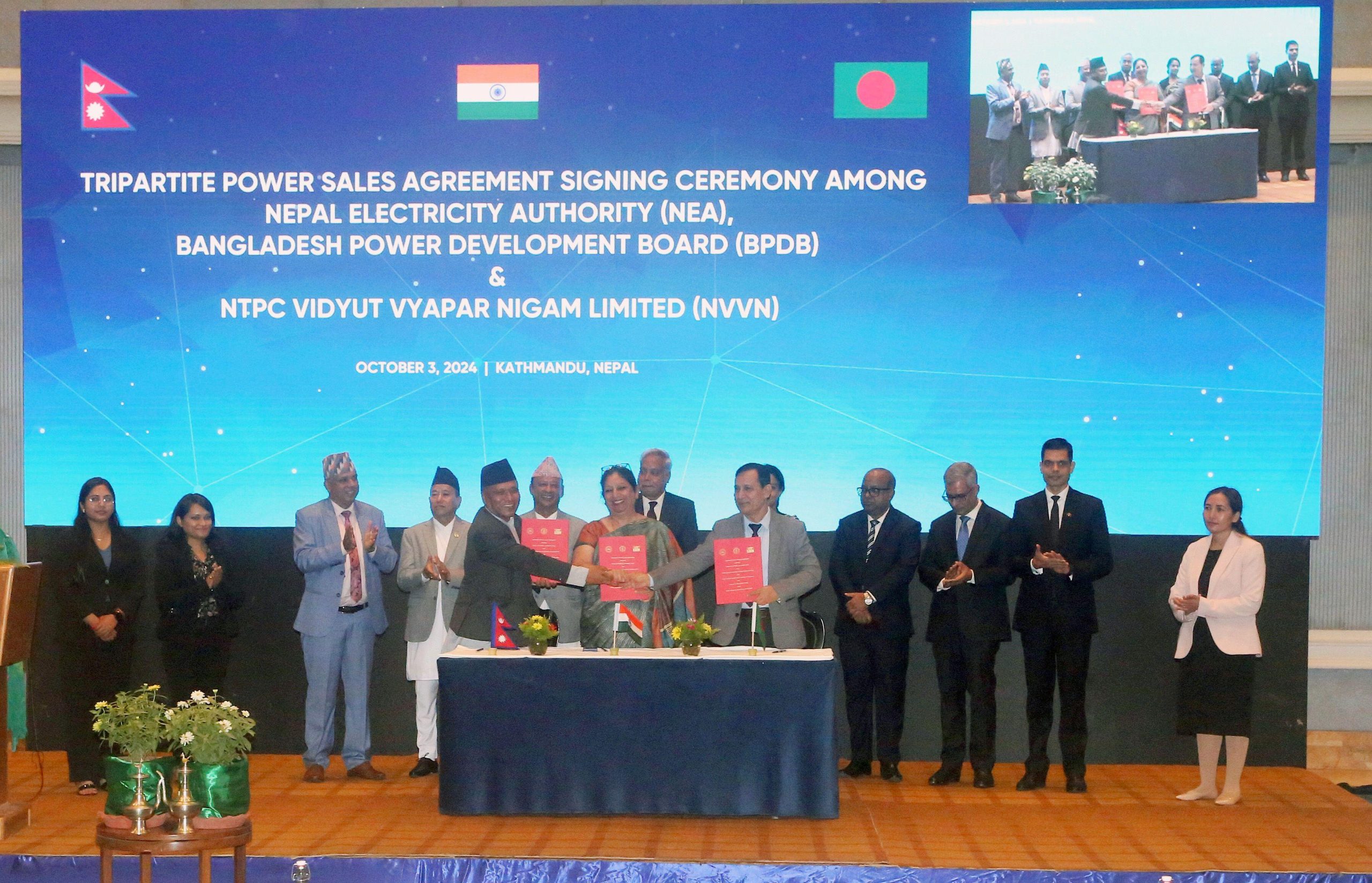 handshake on stage with large crowd