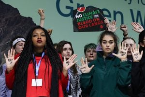 A gathering of young people lifting their hands, sending out message on climate justice