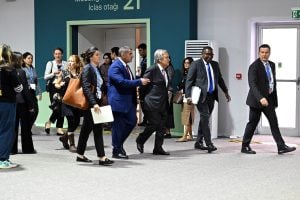 A collective of individuals walking in a hallway