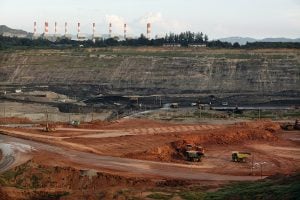 A large mining site featuring trucks and chumminess in the background