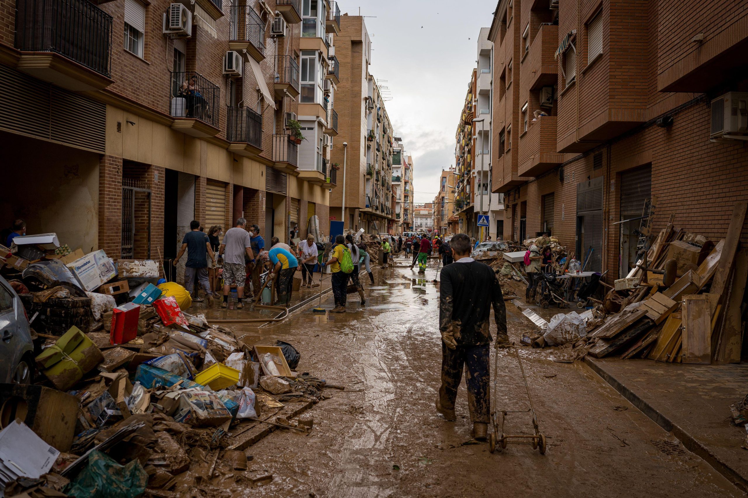 <p>Volunteers clearing muddy streets in Paiporta, Spain, following flash floods that killed more than 200 people in the Valencia region this month. It has already been declared the worst disaster of its kind in modern Spanish history (Image: Davide Bonaldo / ZUMA Press / Alamy)</p>