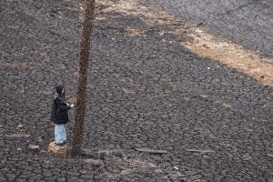 A girl stays at the reservoir at a dam