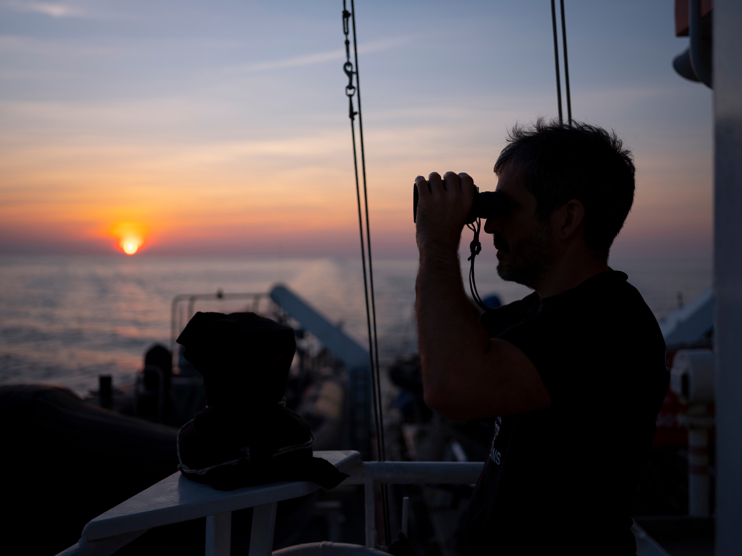 <p>A ship’s captain looks out over the northern Indian Ocean (Image © Abbie Trayler-Smith / Greenpeace)</p>