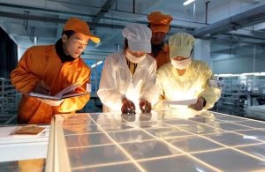 group of people looking down at pv cell