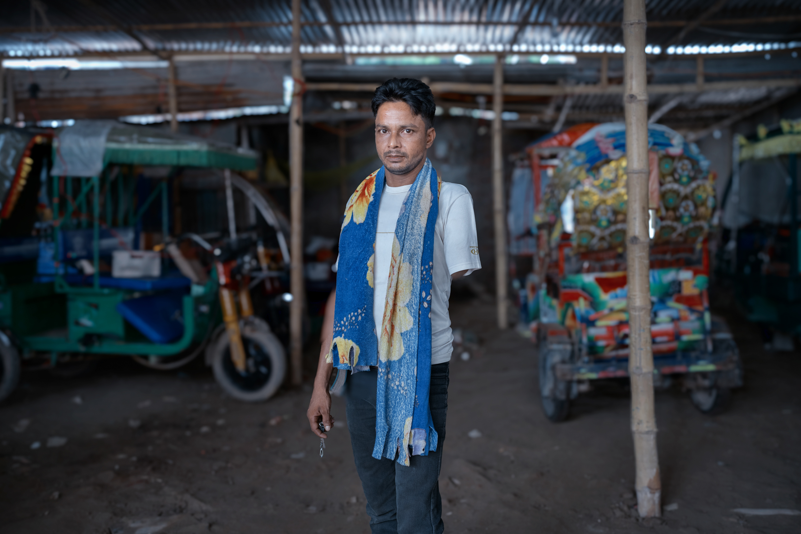 man standing in rickshaw garage