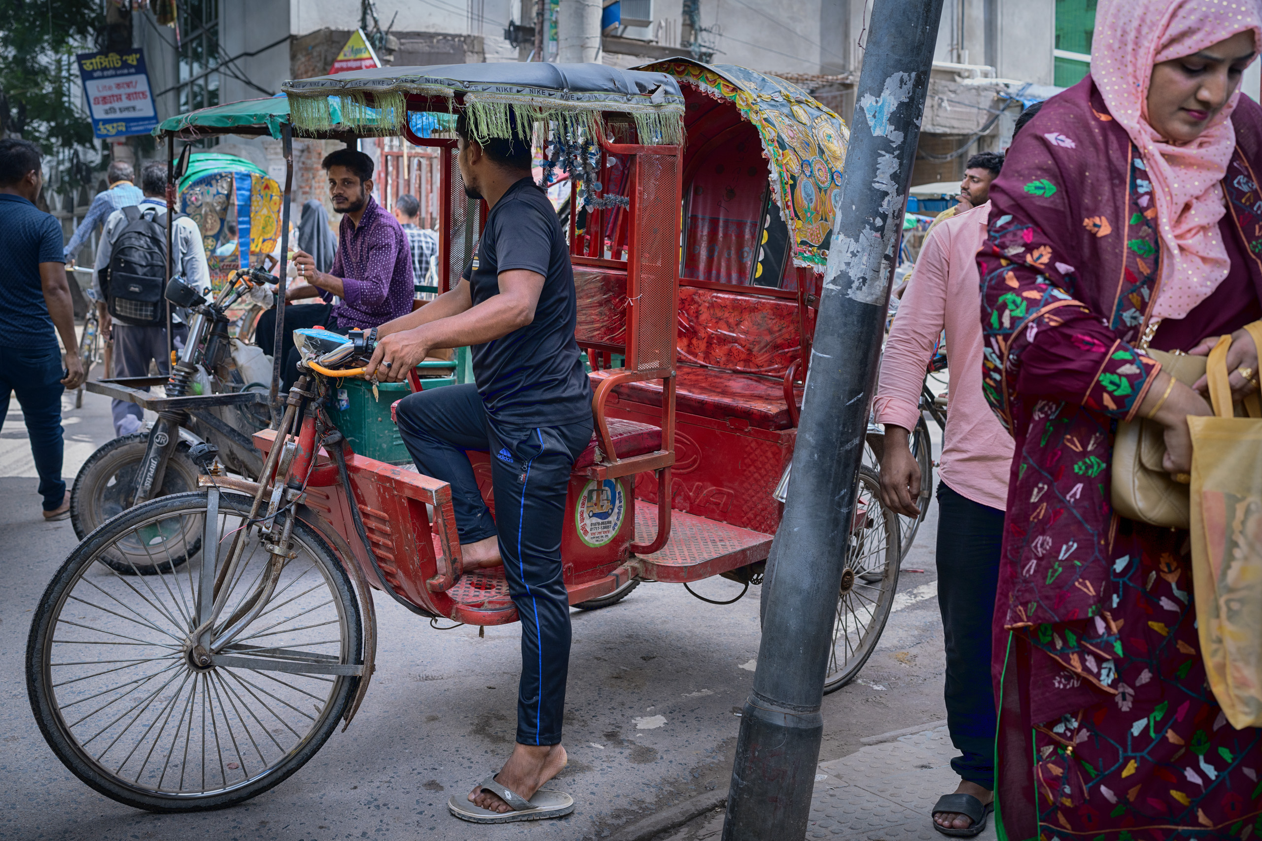 man on pedal-powered rickshaw