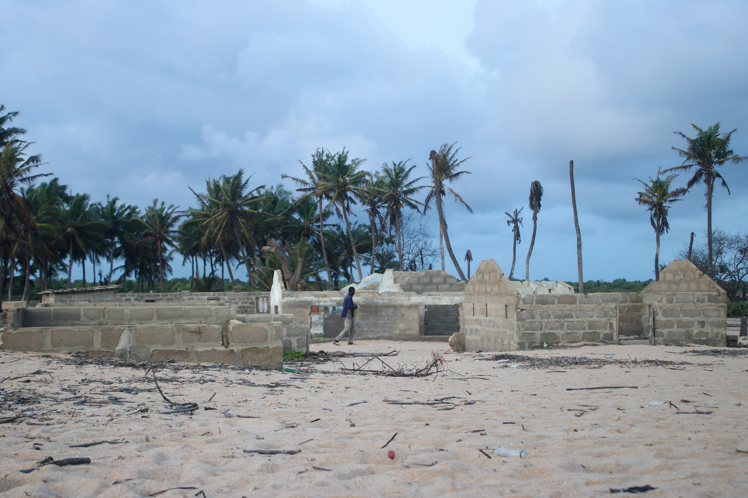 man walking near low concrete ruins