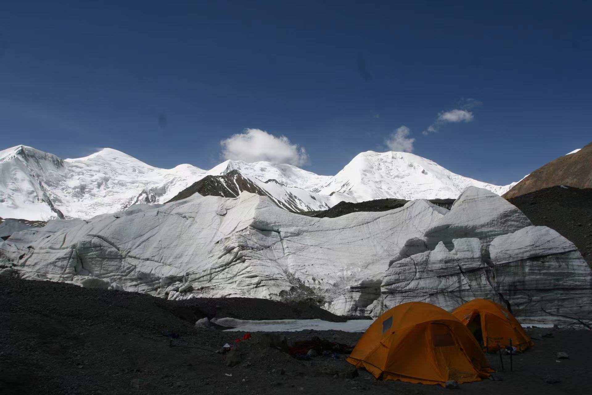 two tents are positioned near a glacier