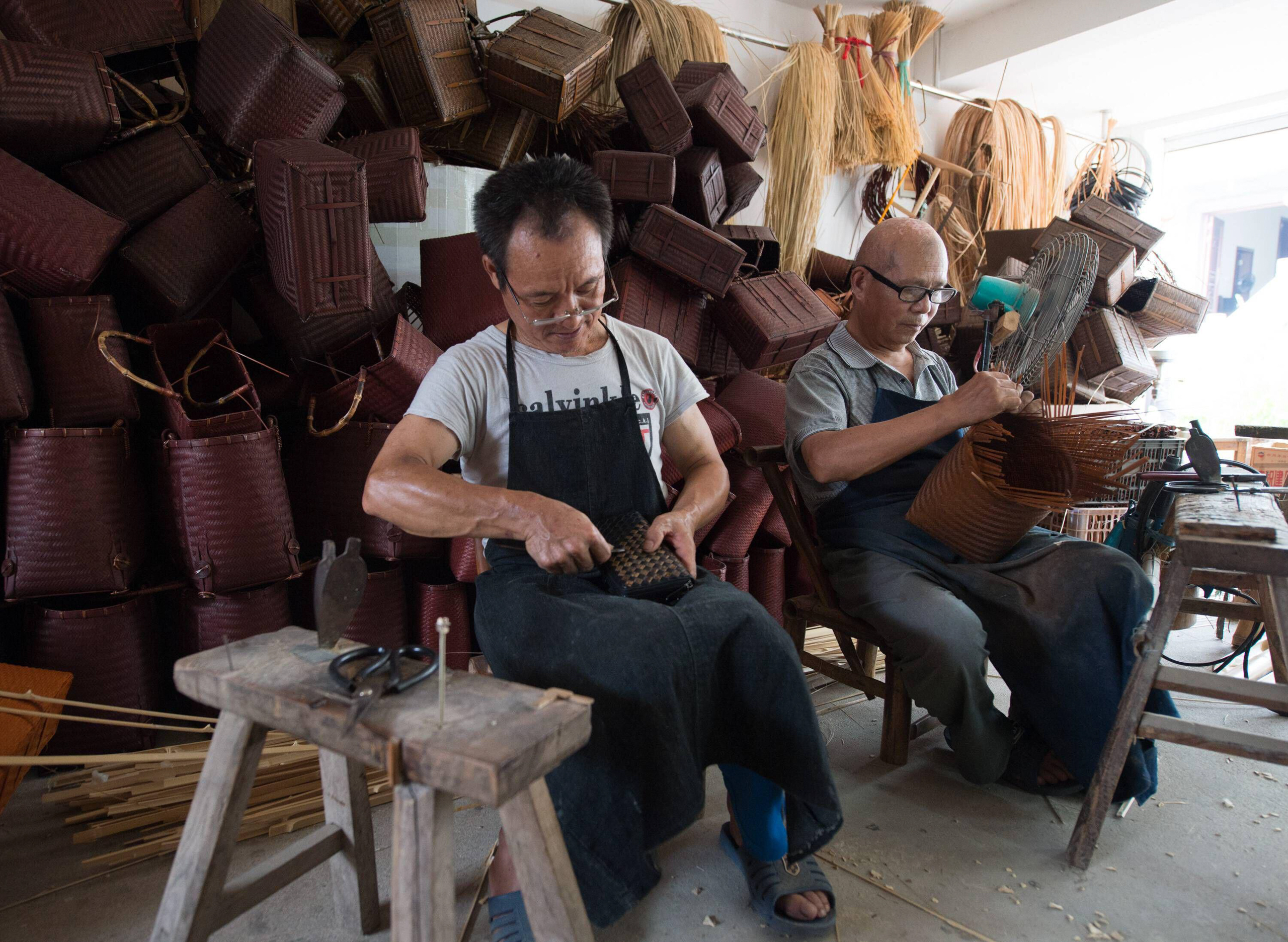 Two old craftsmen make traditional bamboo products