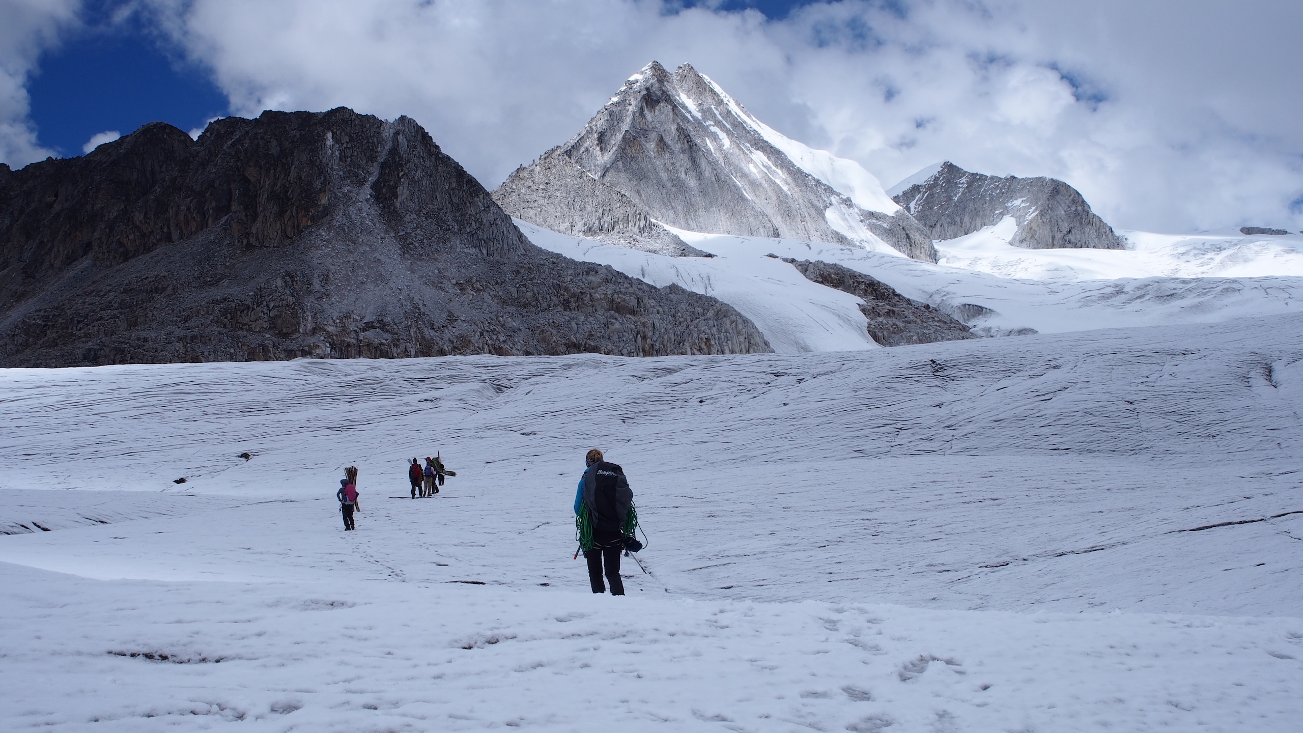 group of people in snow near mountains