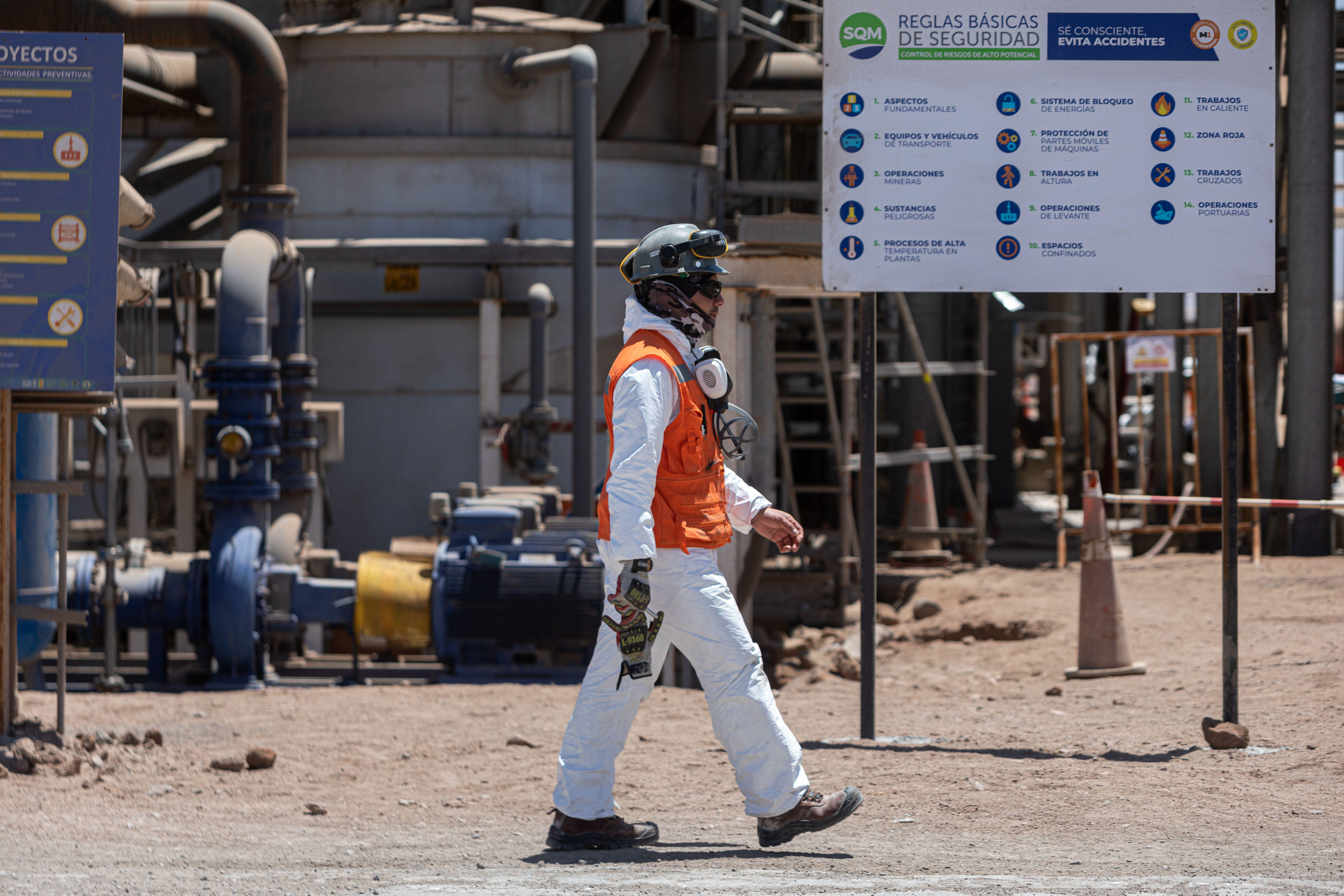 man walking near pipes and machinery