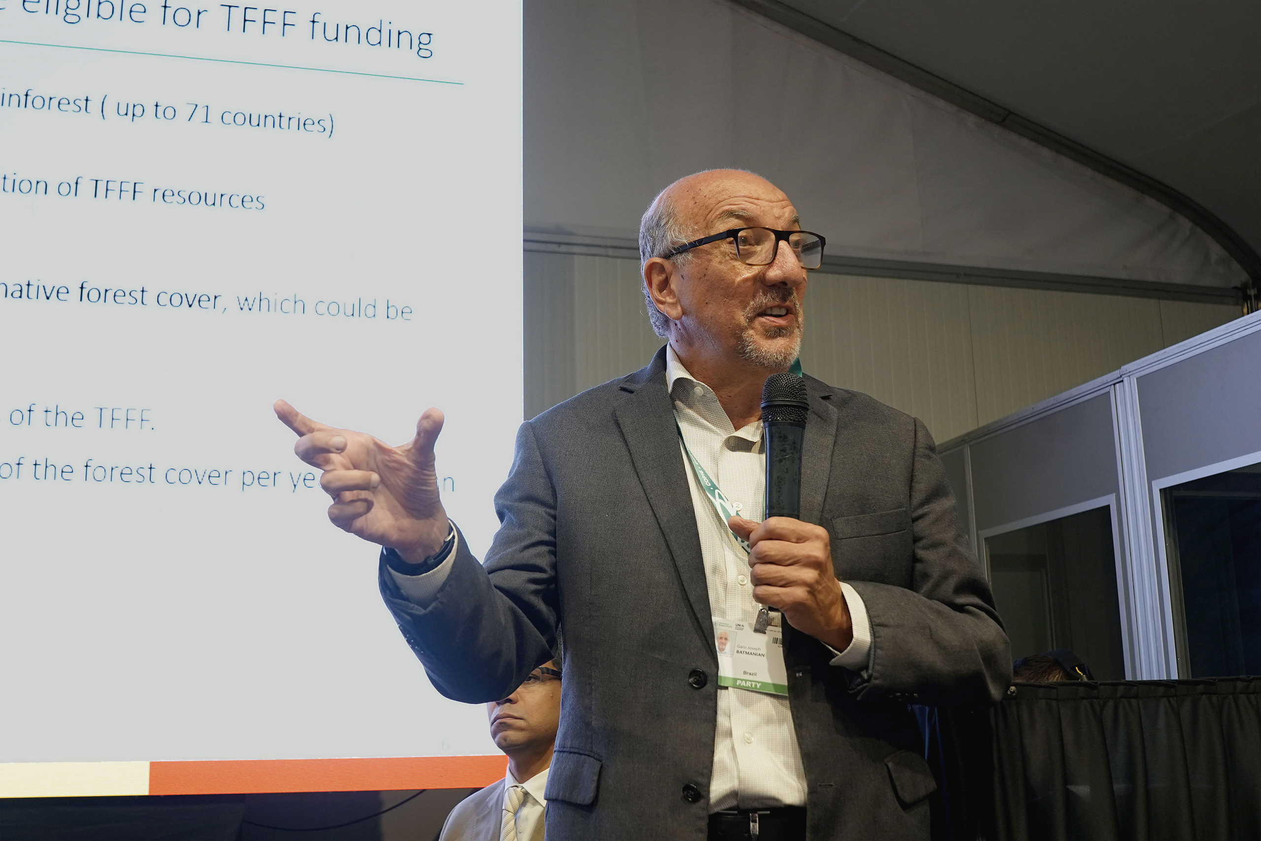 Garo Batmanian gesturing in front of presentation