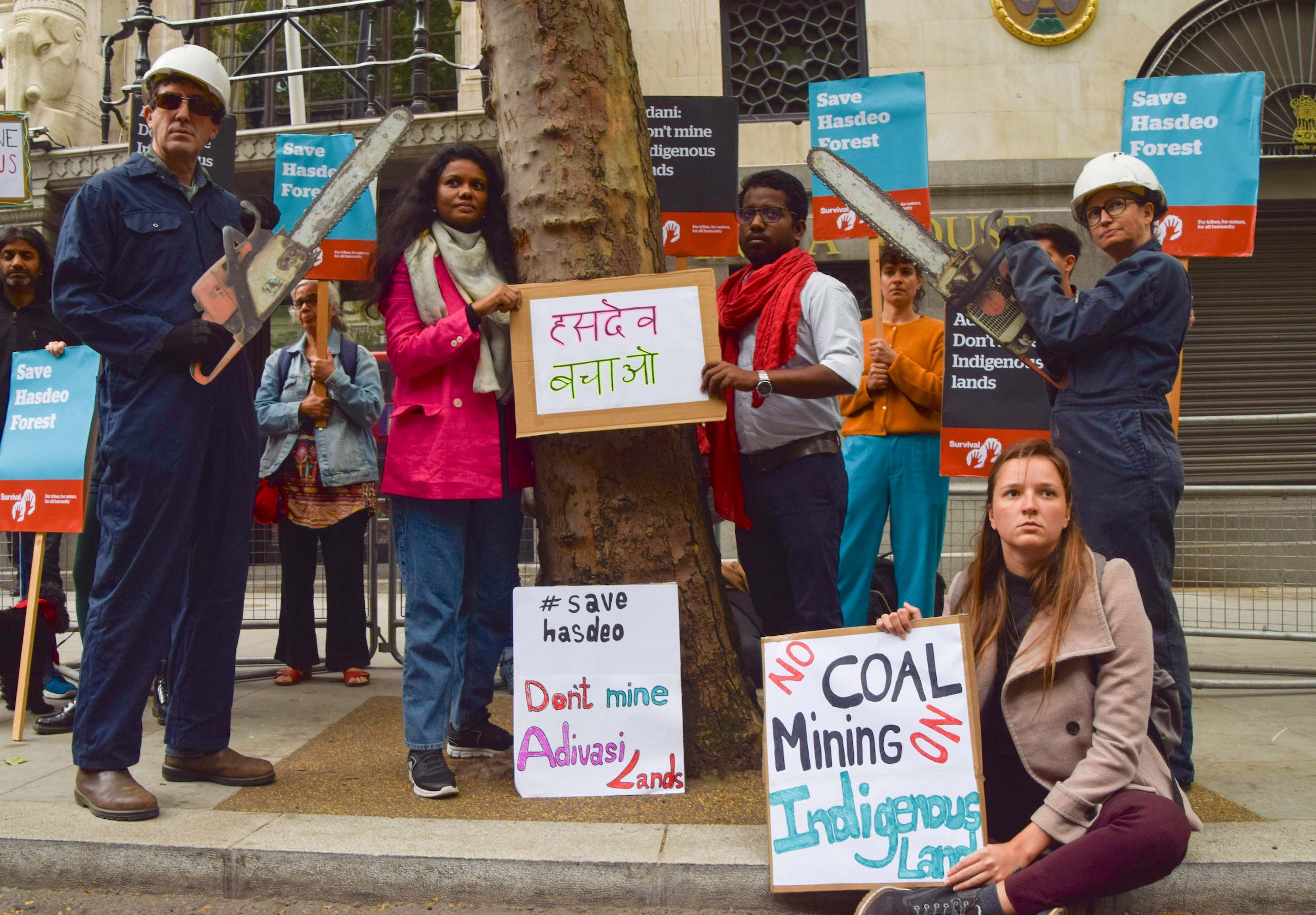 A group of people holding signs protesting outside the court