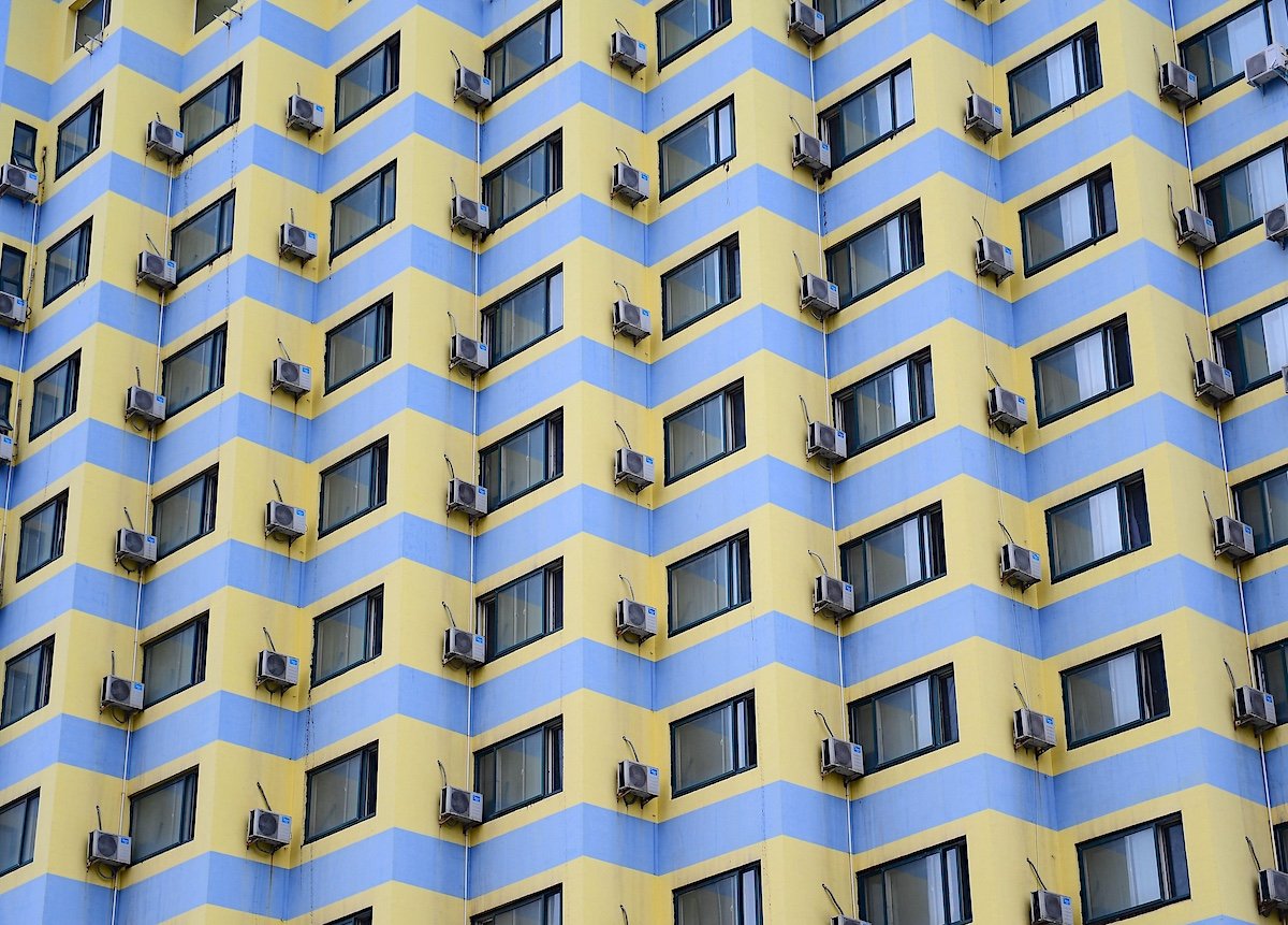 air conditioners are on the wall of a building