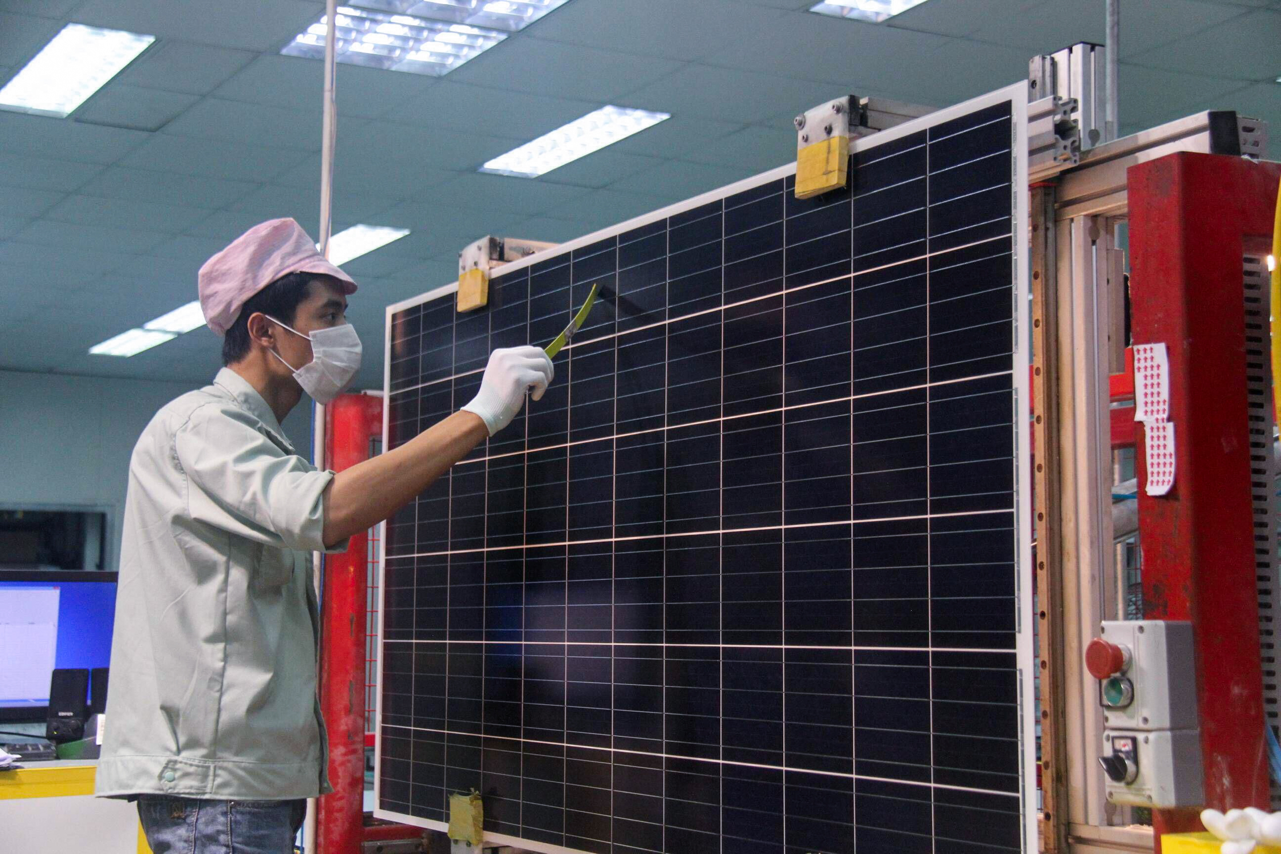 masked man observing solar panel