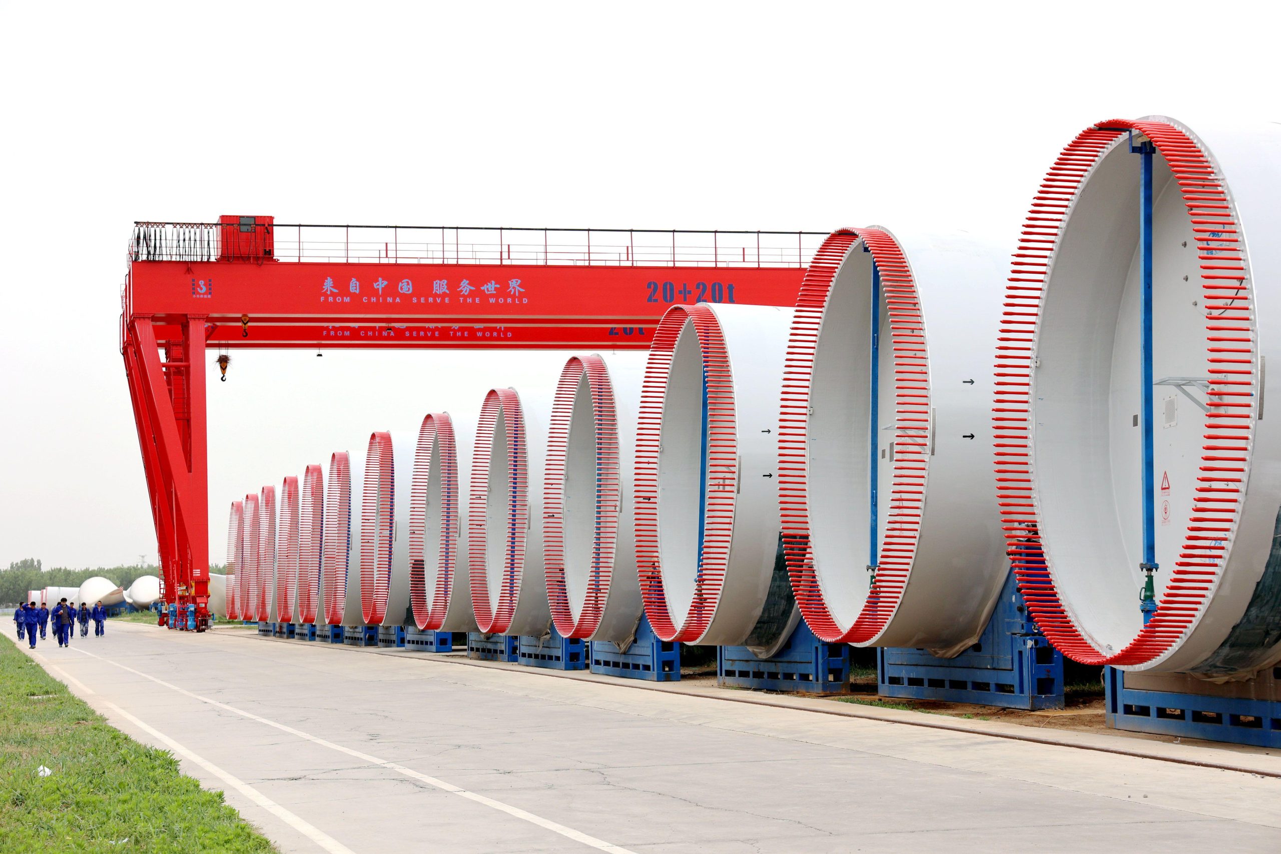 row of wind turbine blades along walkway