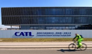 A man rides his bike past the CATL headquarters building in Germany