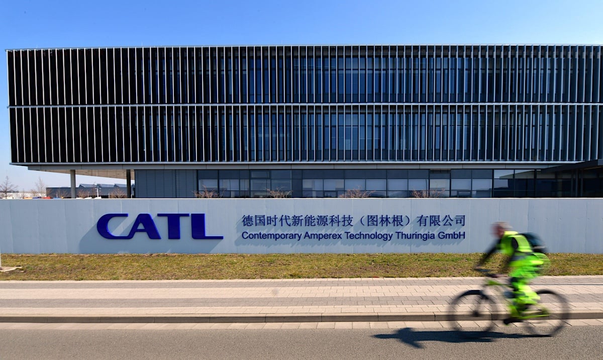 A man rides his bike past the CATL headquarters building in Germany
