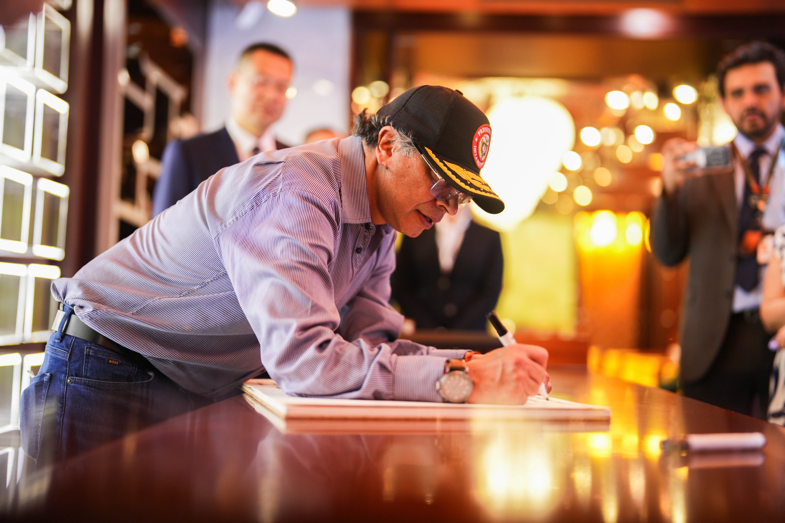 Colombian President Gustavo Petro leaves a message in the notebook