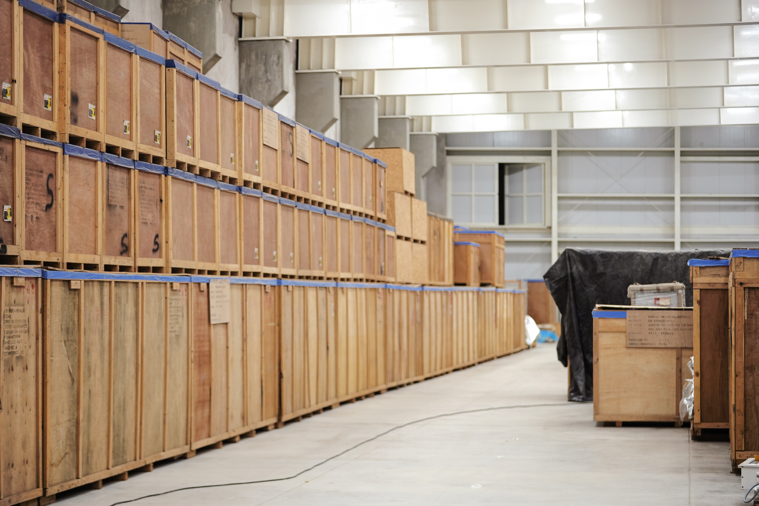 A warehouse filled with stacked wooden crates and boxes