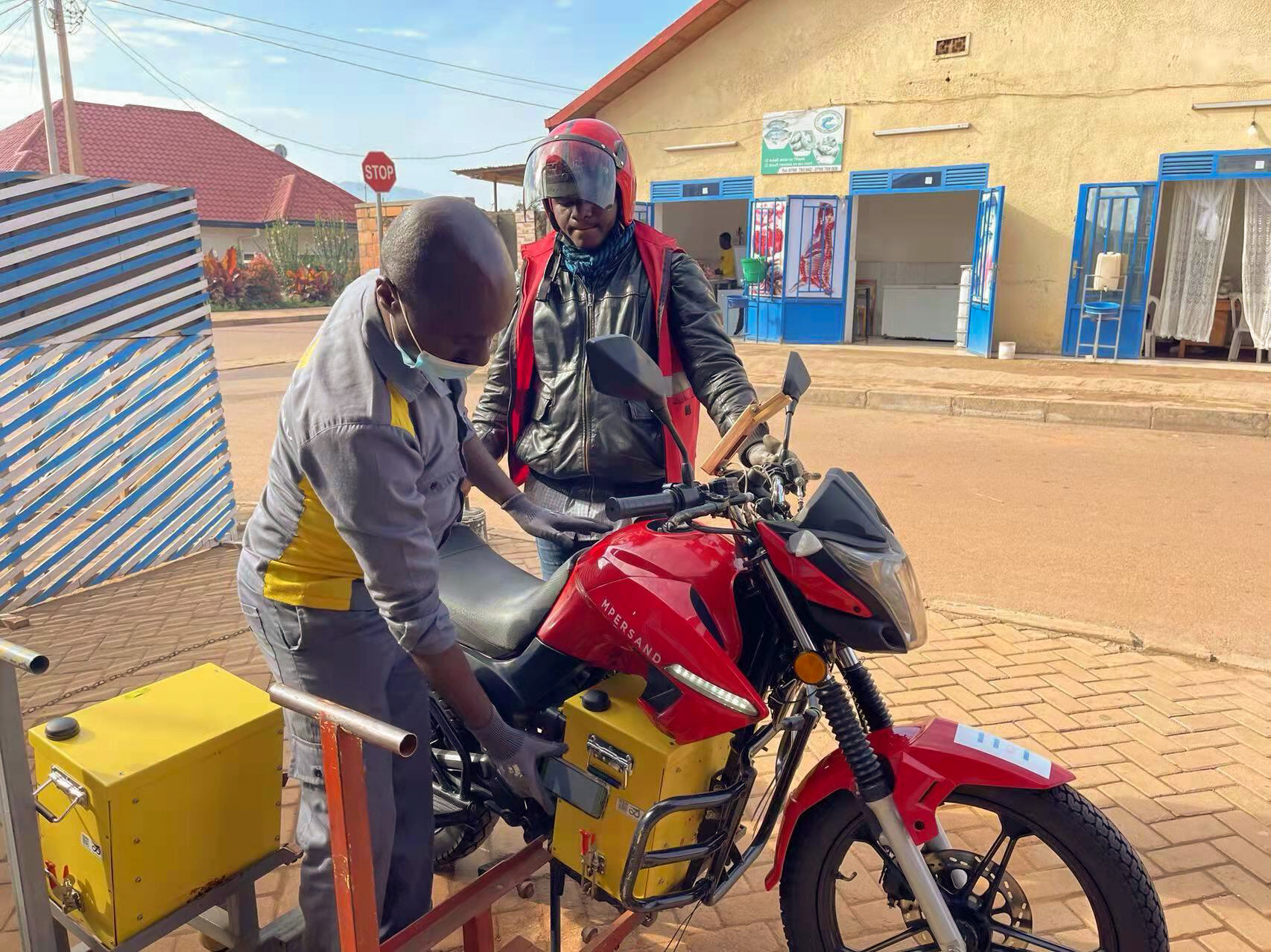 two people standing over motorcycle