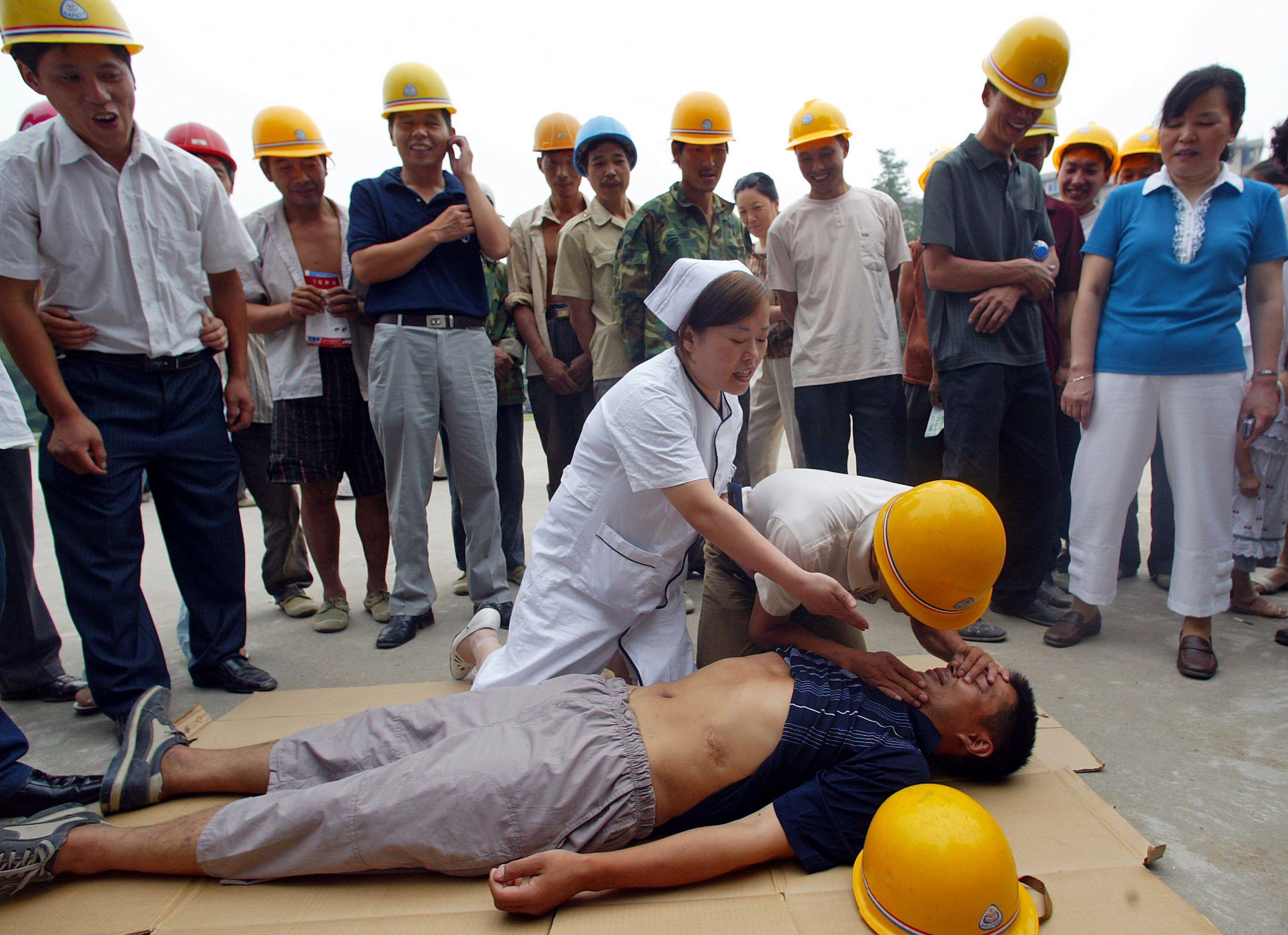 A nurse demonstrates first aid for collapses 