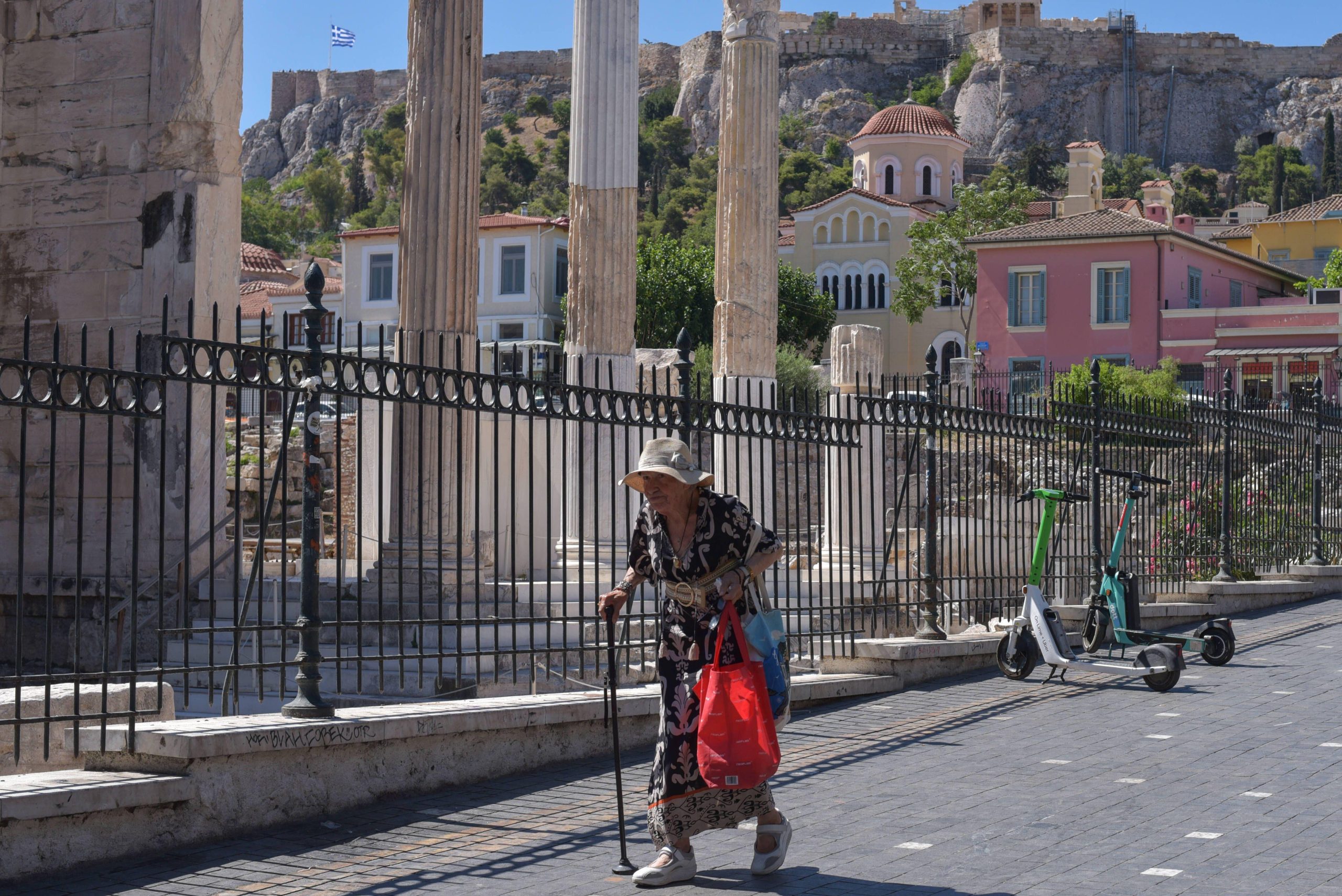 elderly woman with cane walking on street
