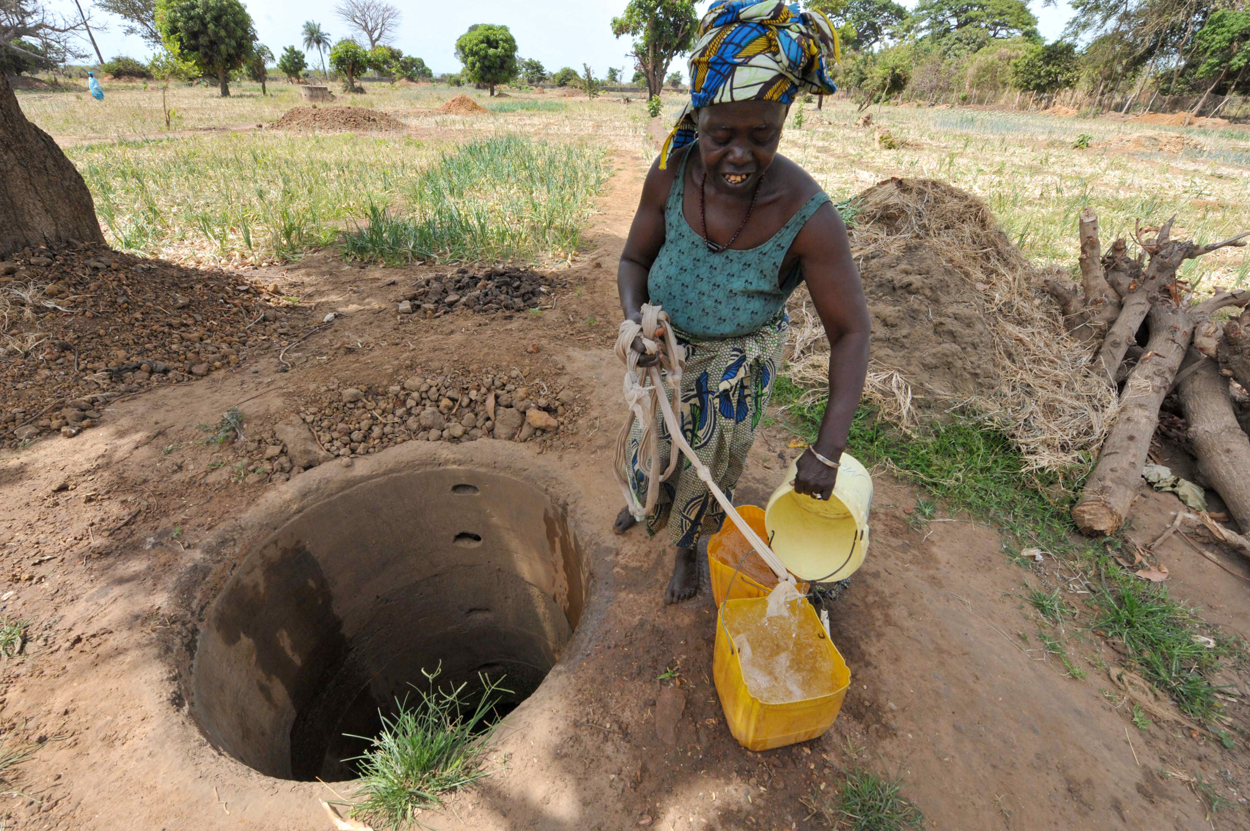 woman collecting water from well
