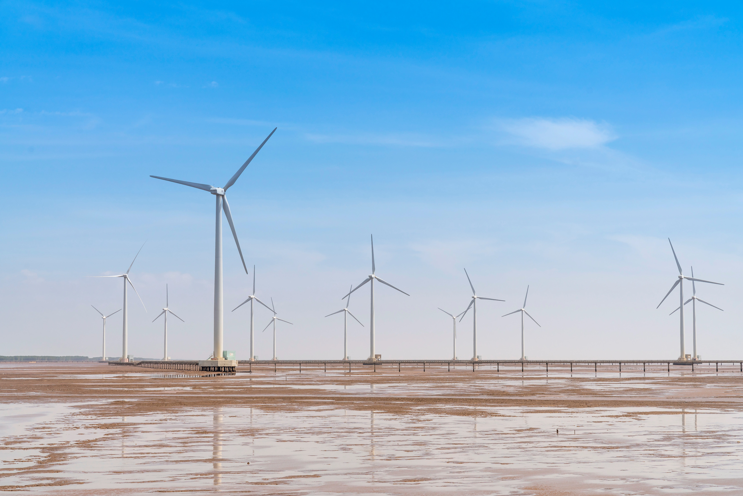low tide seascape with wind turbines