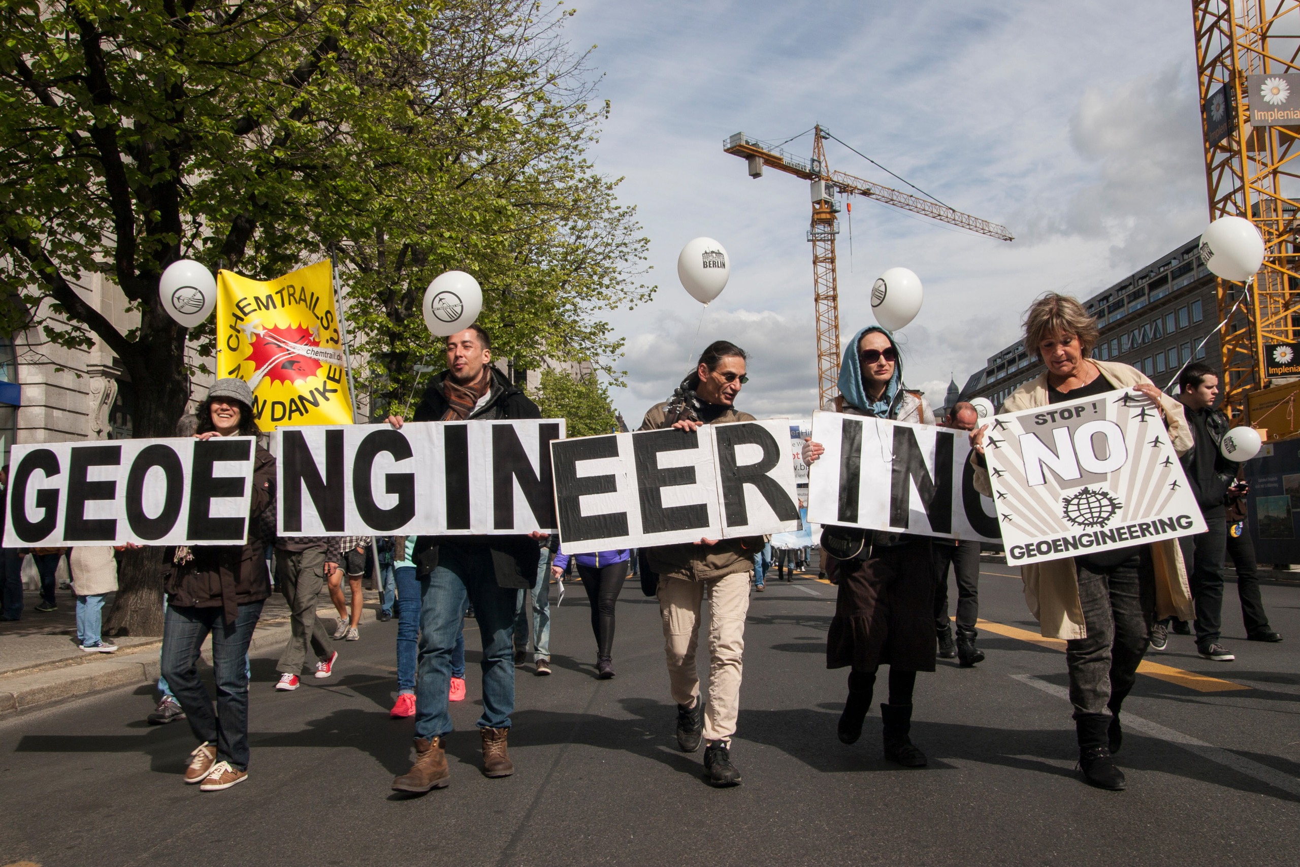 crowd of people marching with placards