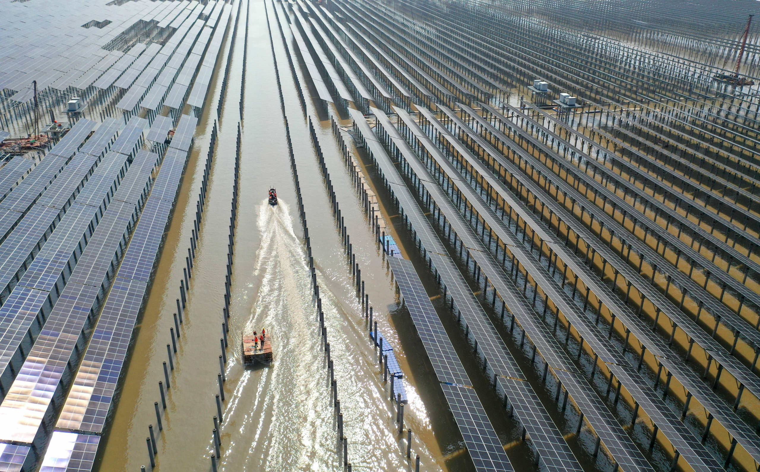 rows of solar panels on water