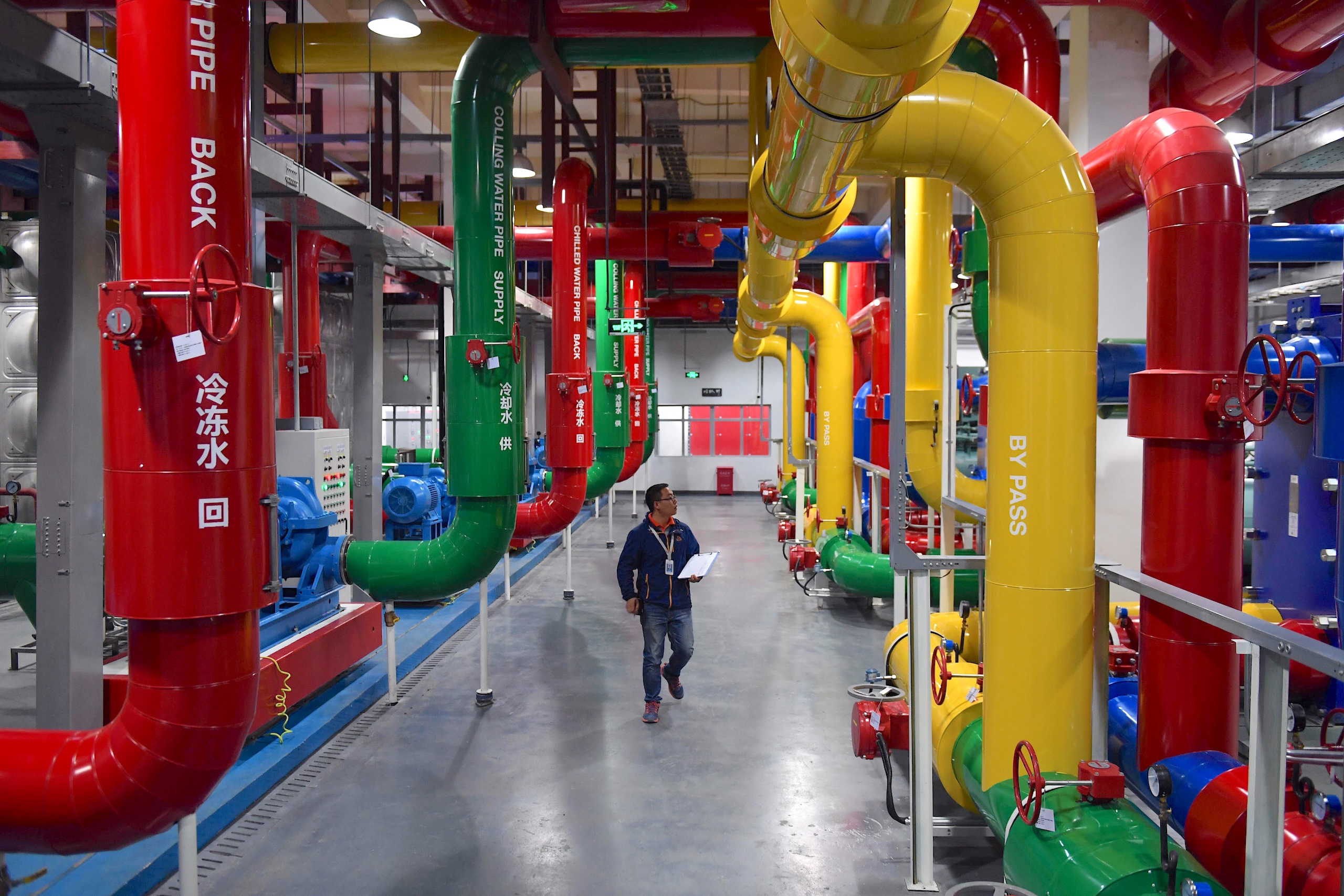 <p>A technician inspects cooling pipes at an Alibaba data centre in Zhangbei, Hebei province. A key emerging challenge for China is how to become a global leader in the energy-intensive AI industry while not jeopardising its climate action targets (Image: Jin Liangkuai / Xinhua / Alamy)</p>