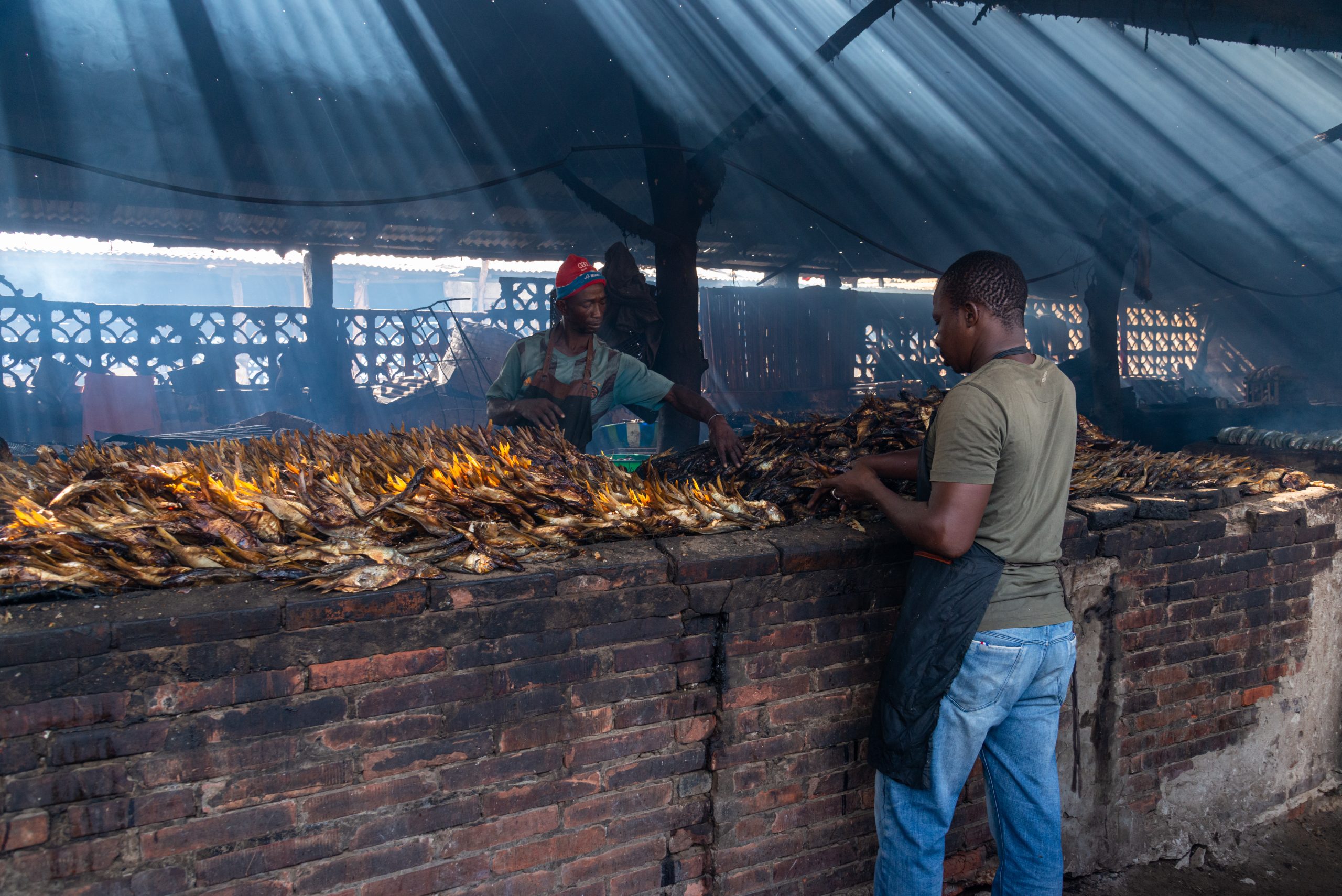 peoople standing over drying sardinella