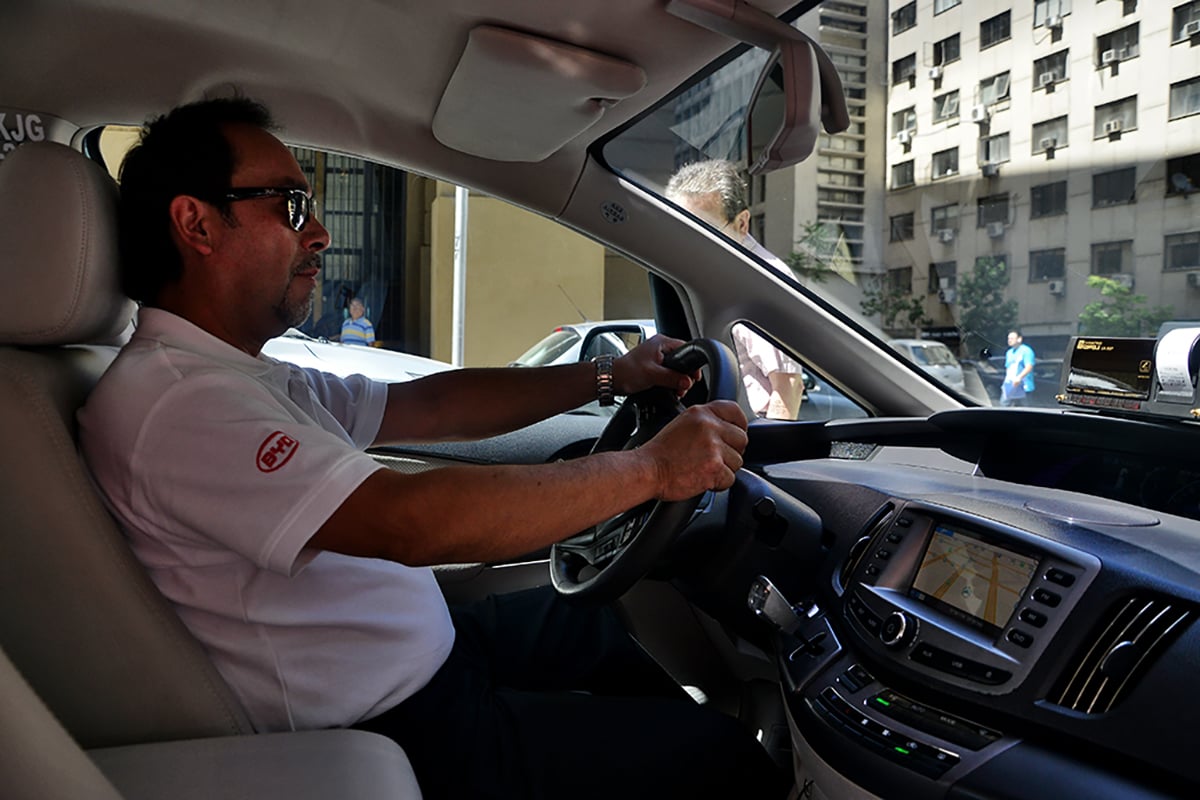 man holding steering wheel