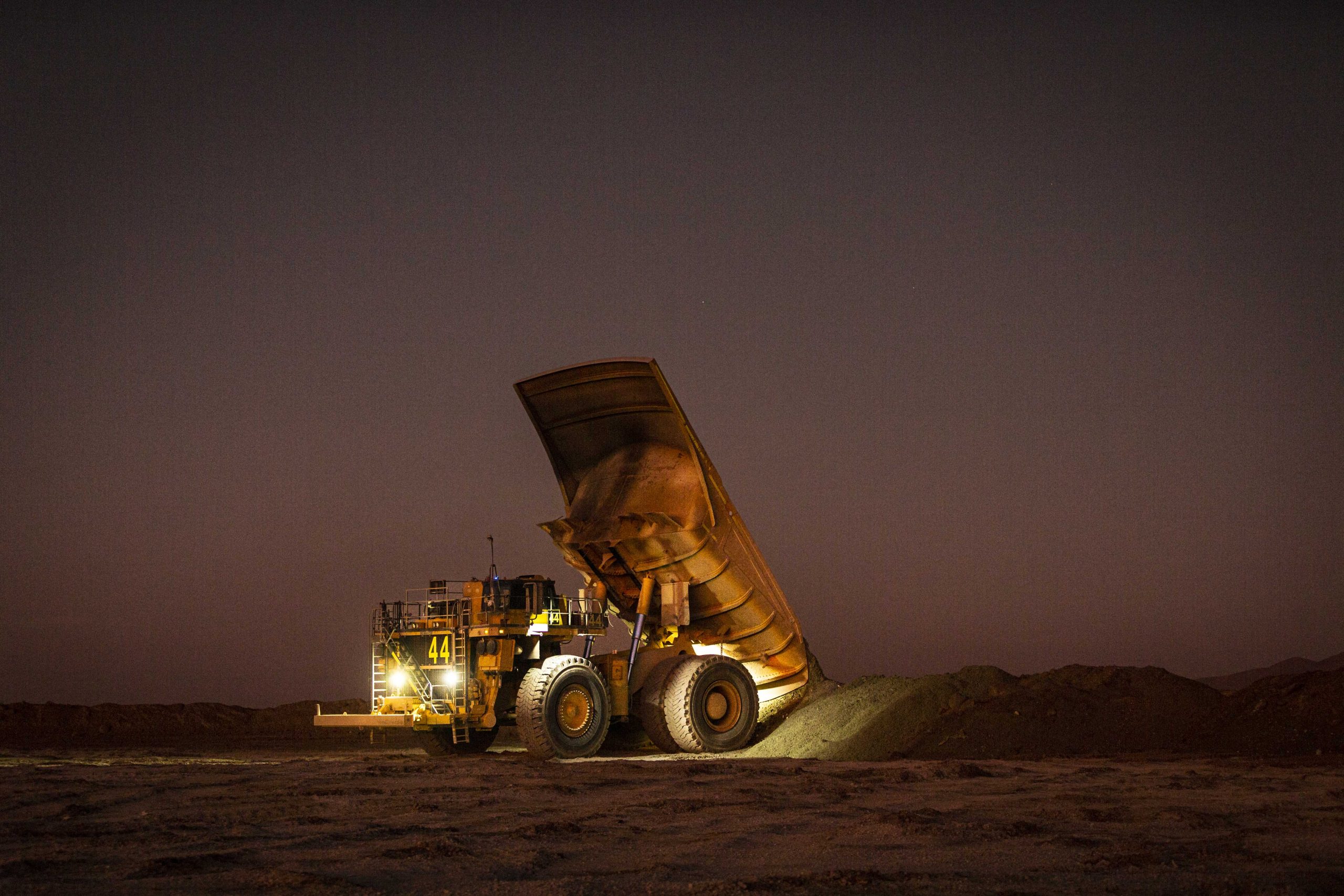 truck dumping ore onto large pile