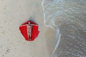 Aerial view of a person lying on the beach