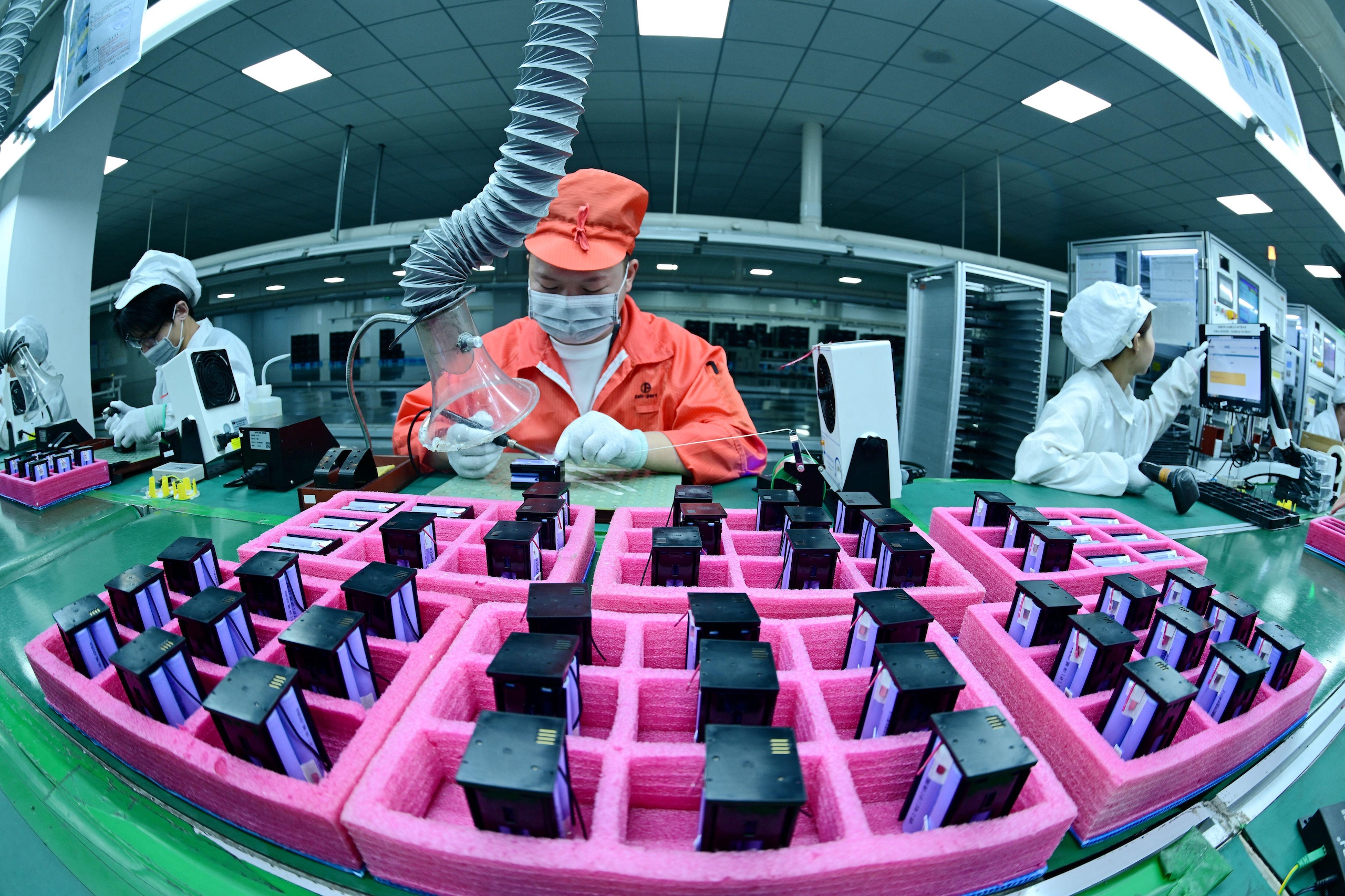 Workers are working on a assemble line in a workshop