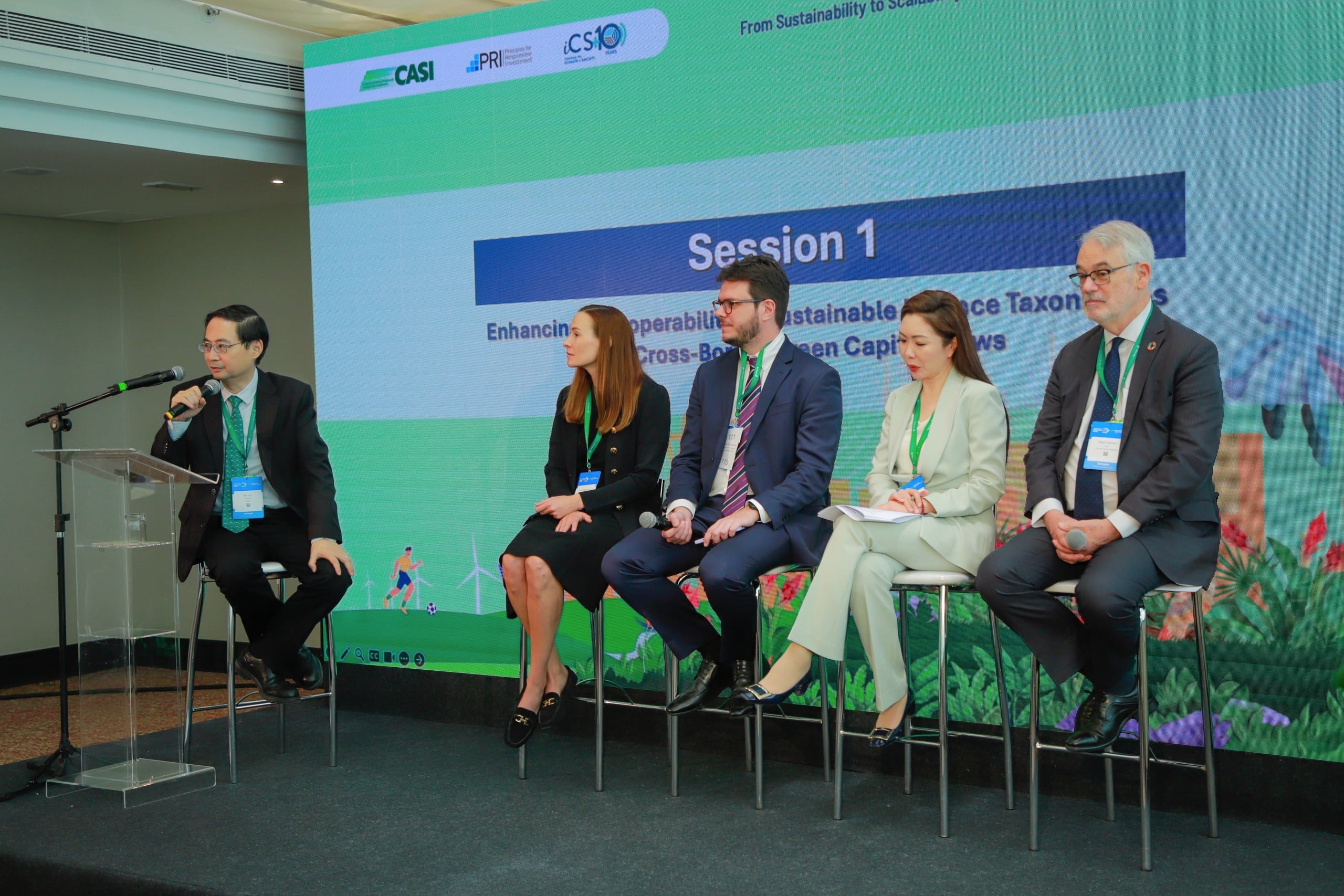 Panel discussion on sustainable finance taxonomies, featuring five speakers at a conference