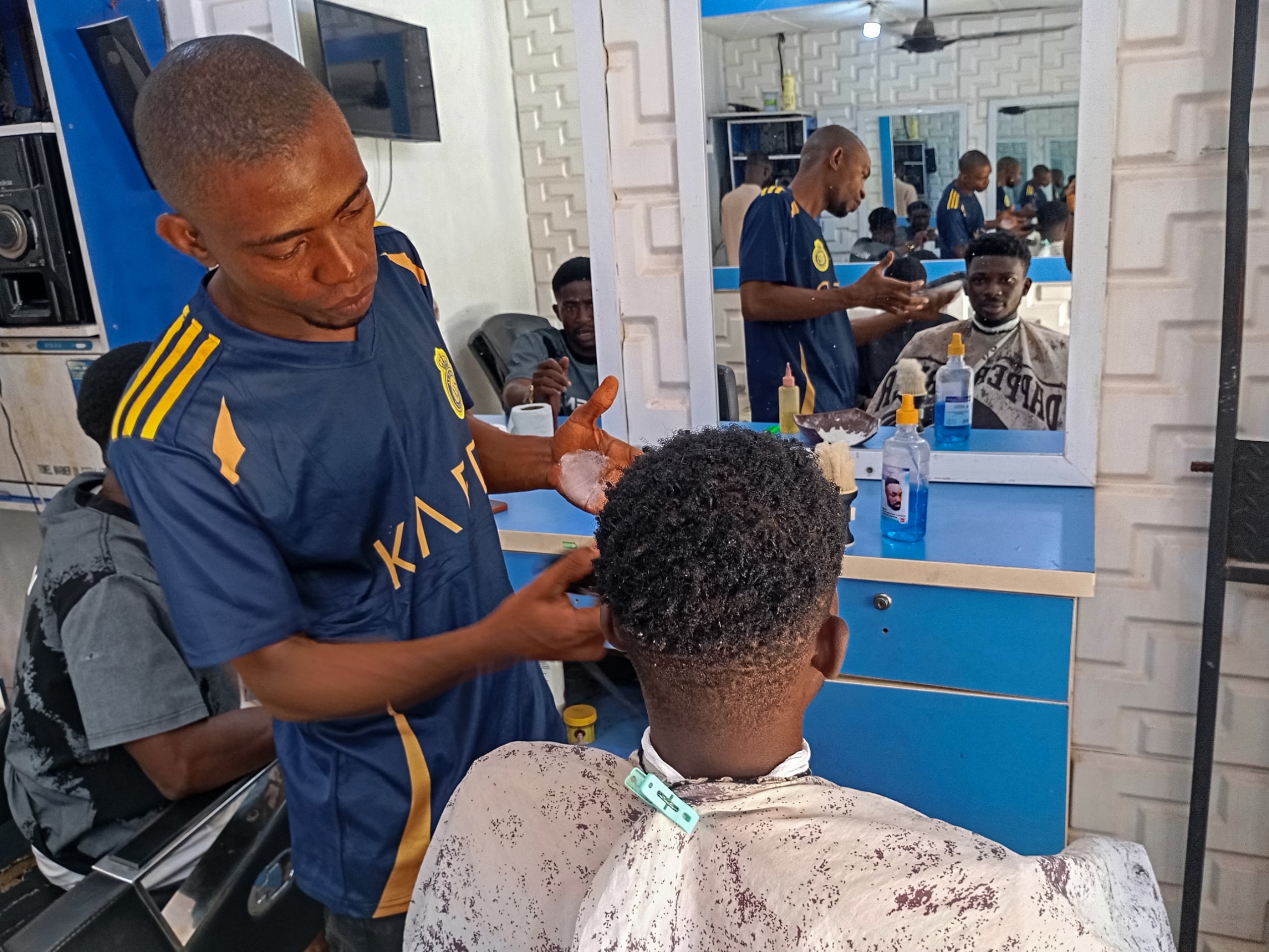 man receiving haircut from barber