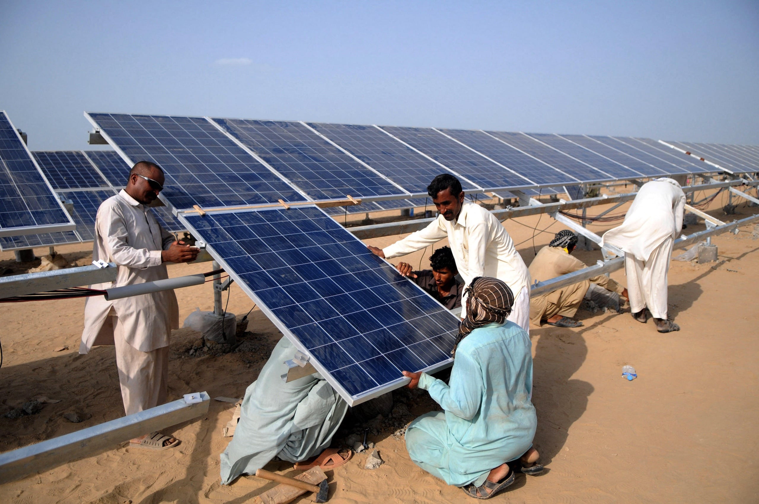 <p>Installing solar panels at the Quaid-e-Azam Solar Park in Bahawalpur, Punjab, a project under the China-Pakistan Economic Corridor (Image: Ahmad Kamal / Xinhua / Alamy)</p>