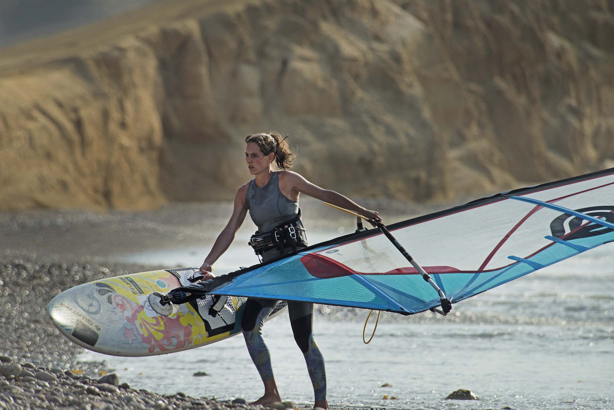 woman holding windsurfing board